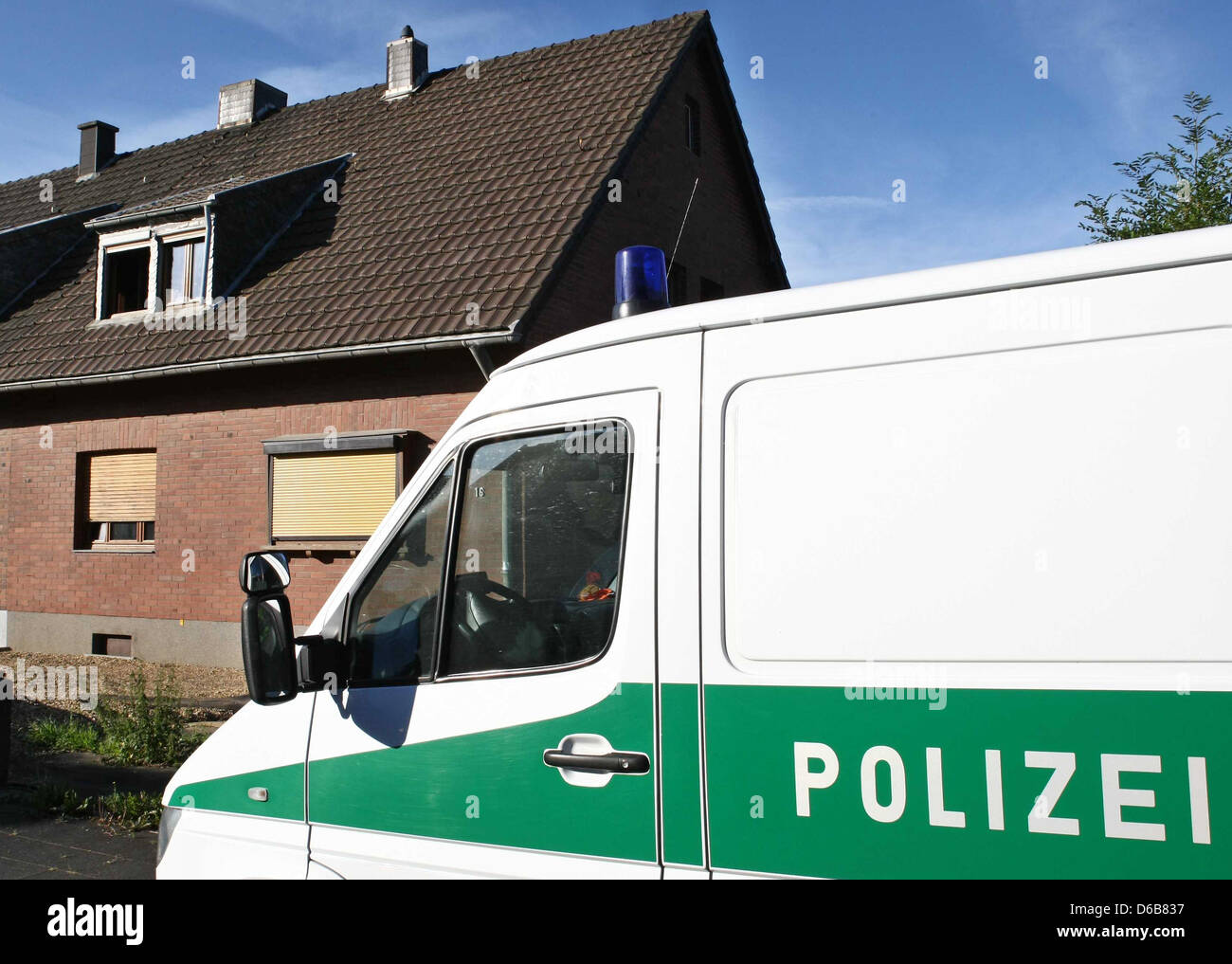 A police vehicle is parked outside during a house search of right-wing extremist organization 'Kameradschaft Aachener Land' in Juelich, Germany, 23 August 2012. Police were out in force after the North Rhine-Westphalian Interior Minister outlawed three right-wing extremist organizations, the 'Kameradschaft Aachener Land', the 'Nationaler Widerstand Dortmund' and the 'Kameradschaft  Stock Photo