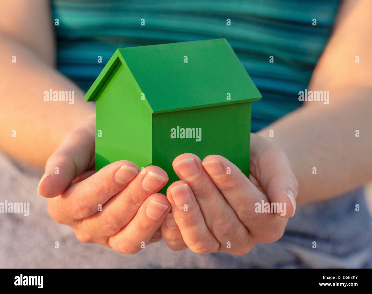 Hands holding model house outdoors Stock Photo