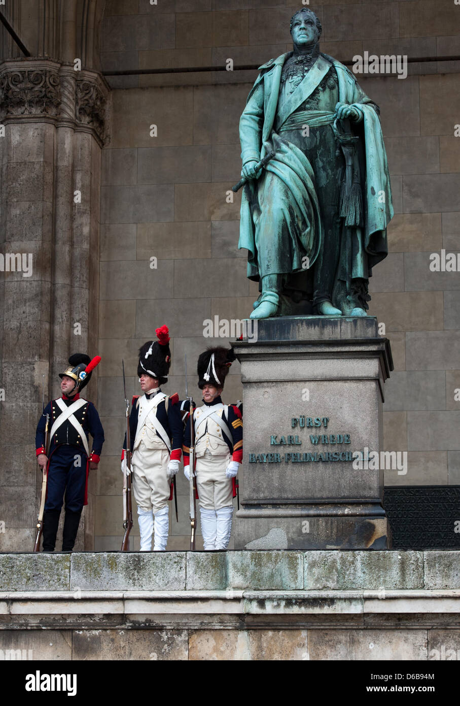 Three men wearing historical military uniforms stand next to a memorial of Bavarian field-marshal Karl Philipp von Wrede at the monumental loggia Feldherrnhalle in Munich, Germany, 24 August 2012. The three men created a perfect atmosphere during a press event initiated for the presentation of a book on the historical topic 'Napoleon and field-Marshal Wrede'. Photo: PETER KNEFFEL Stock Photo