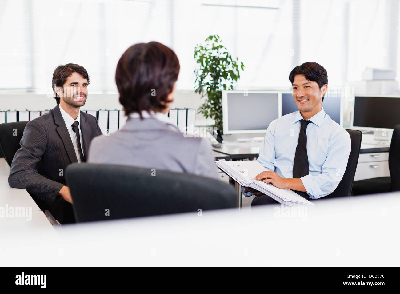 Businessmen talking in office Stock Photo