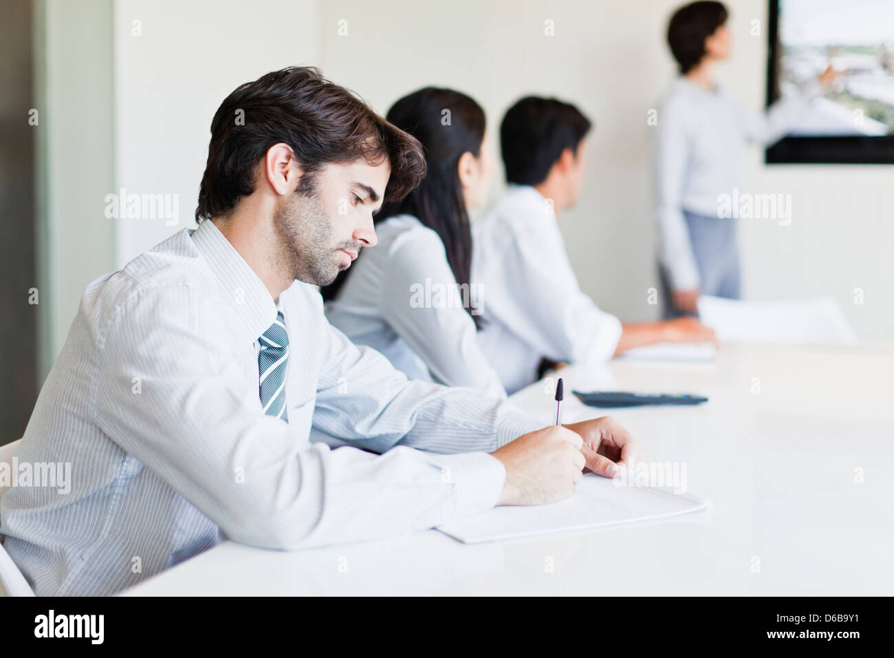 Businessman taking notes in meeting Stock Photo
