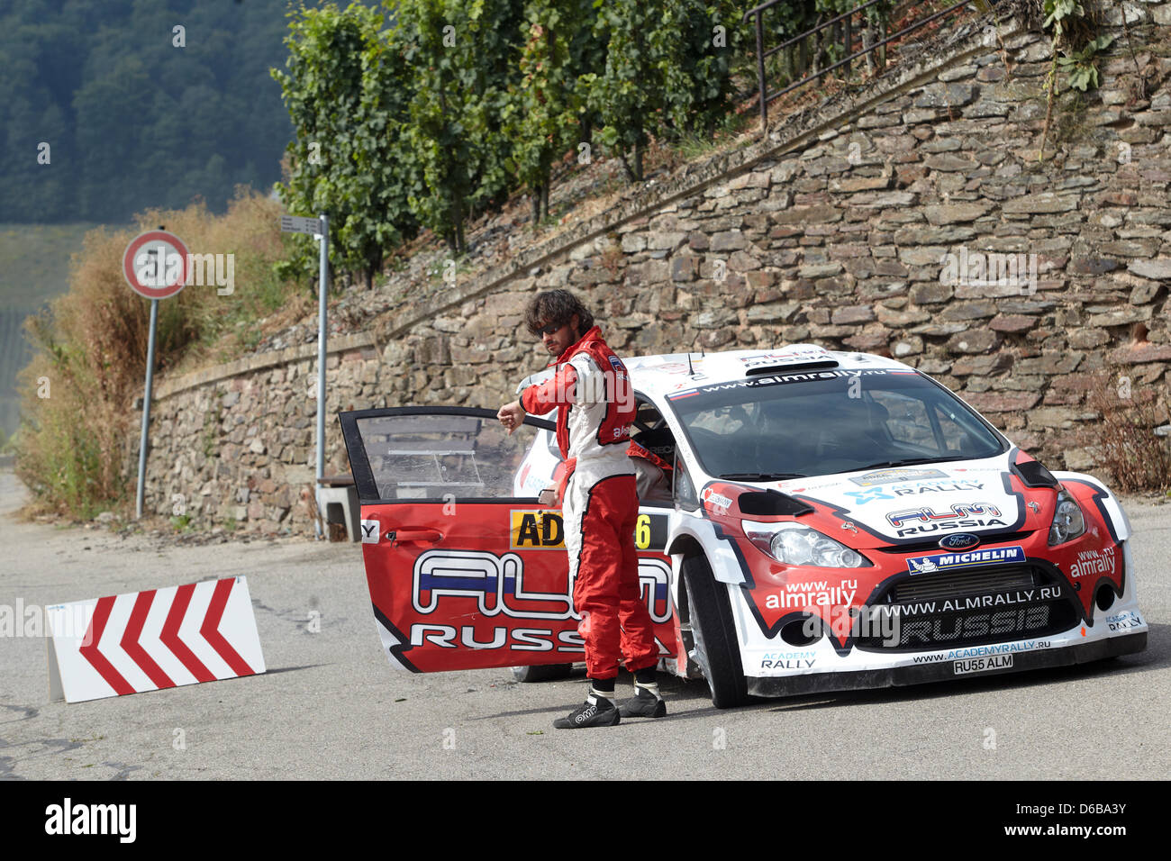 Russian rally driver Evgeny Novikov looks at his watch after a ...