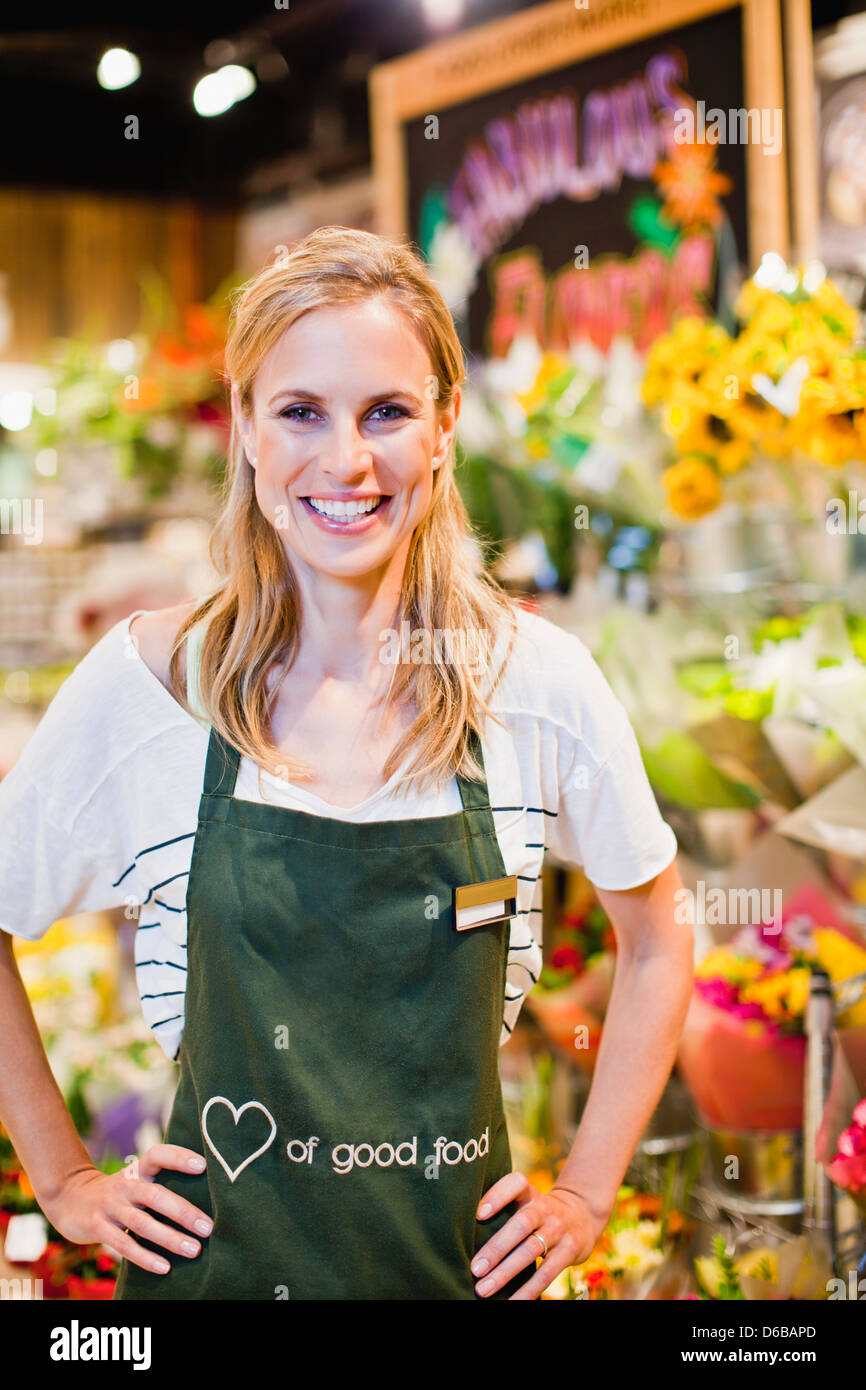 Grocer smiling in florist section Stock Photo