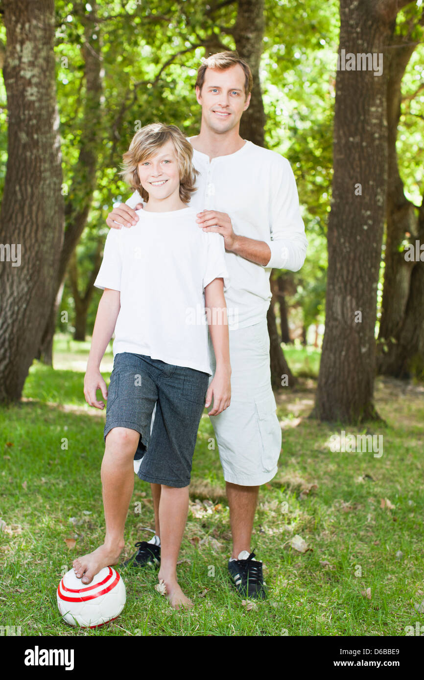 Father and son smiling in park Stock Photo