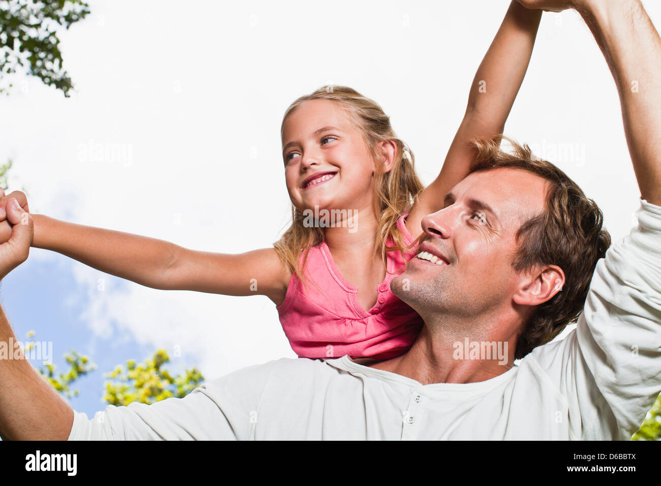 Father carrying daughter in park Stock Photo - Alamy