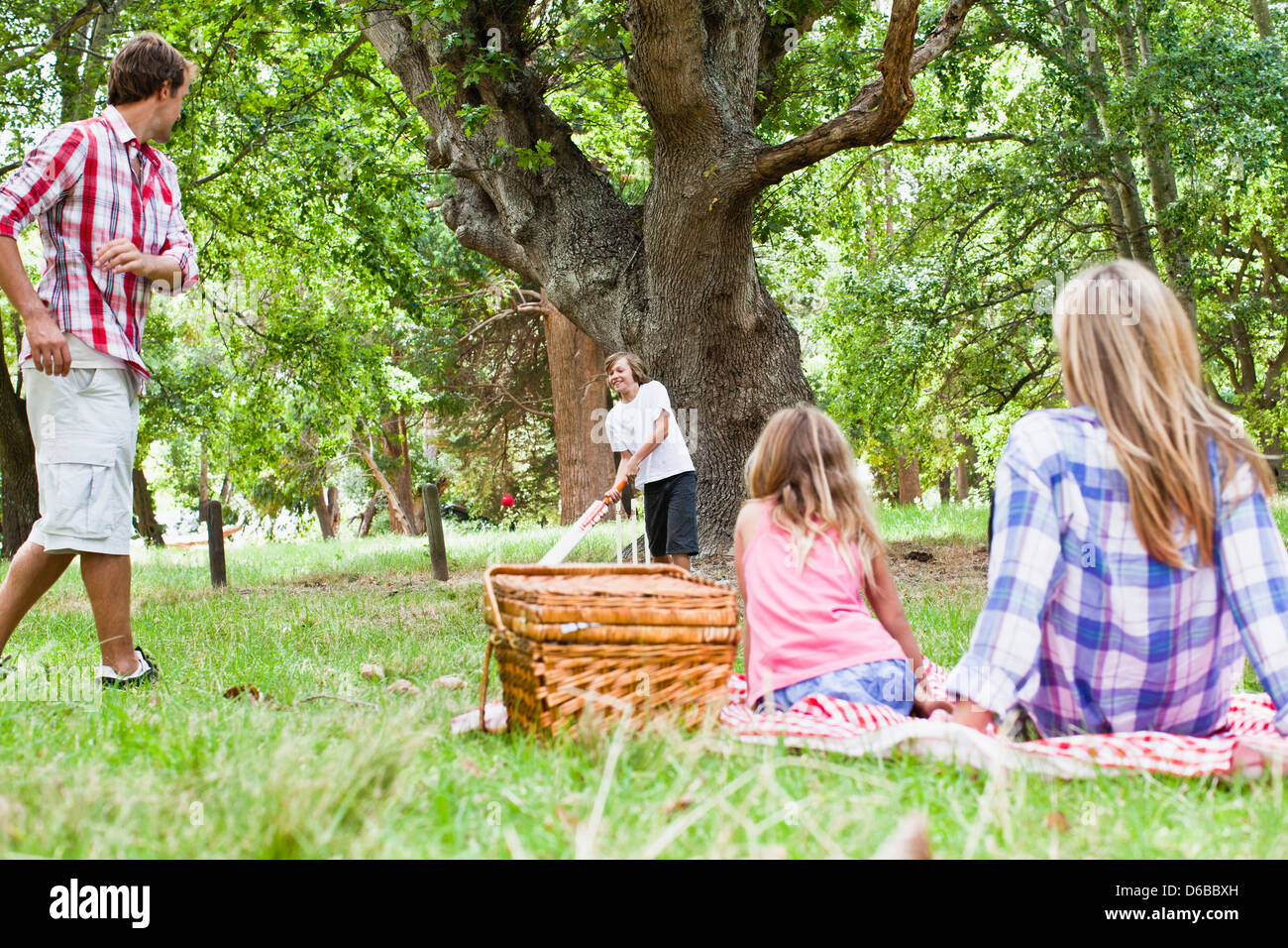 Family relaxing together in park Stock Photo