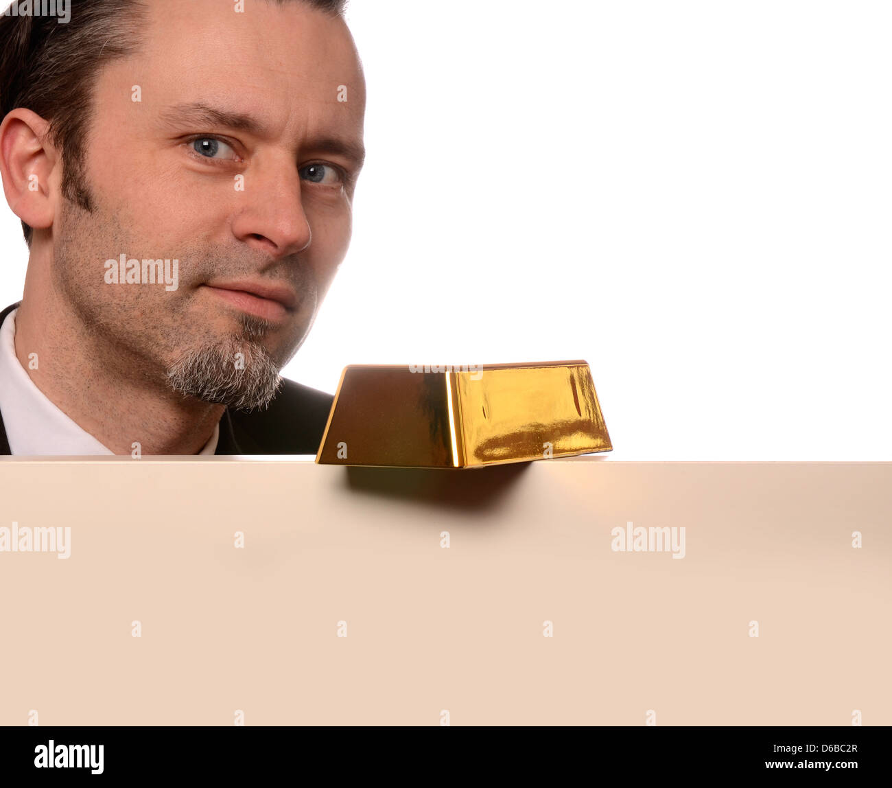 Business man with a fine gold bar on a blank board Stock Photo Alamy