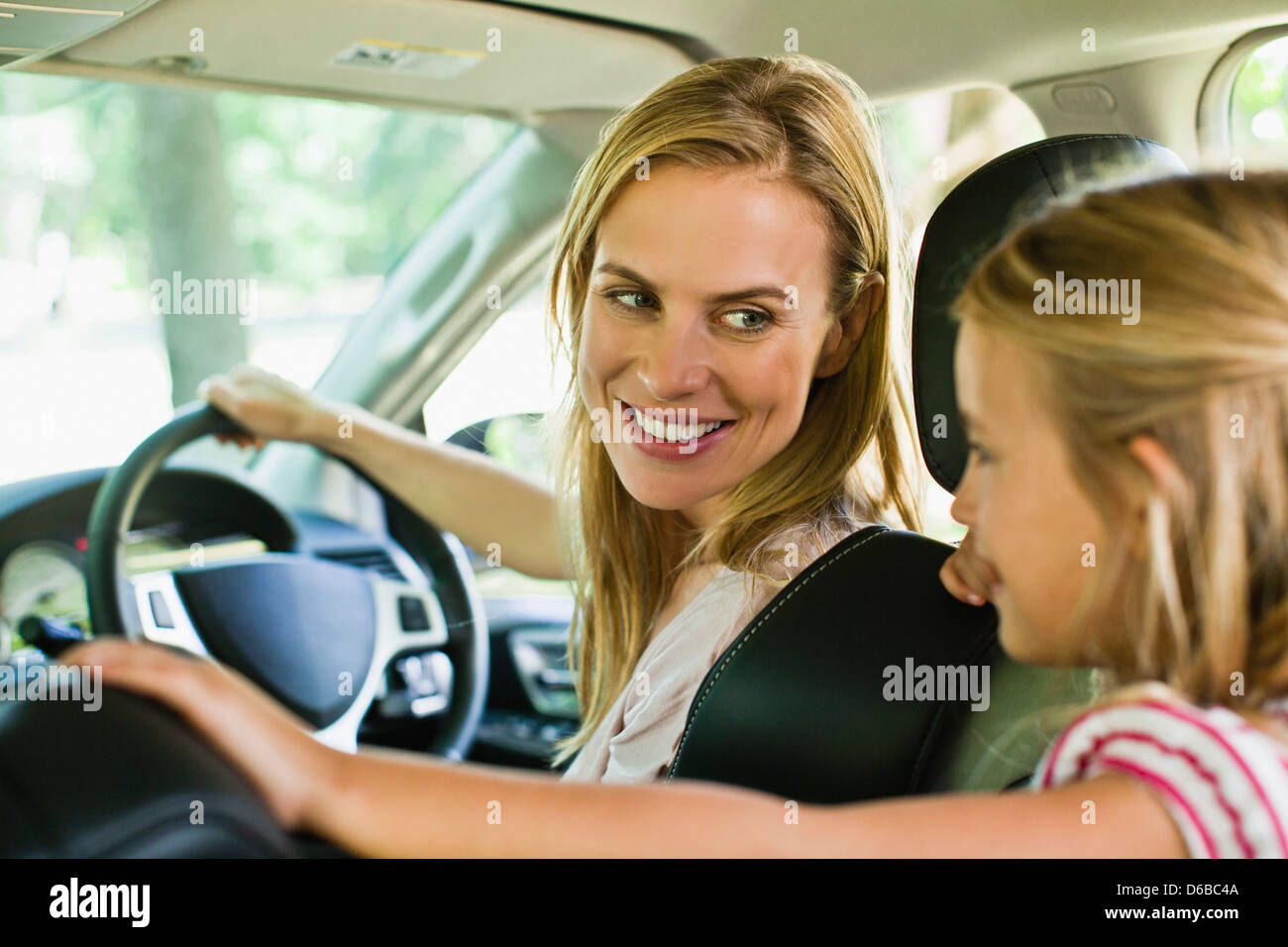 Mother and daughter talking in car Stock Photo