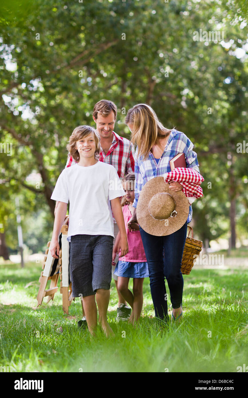 Family with picnic basket in park Stock Photo