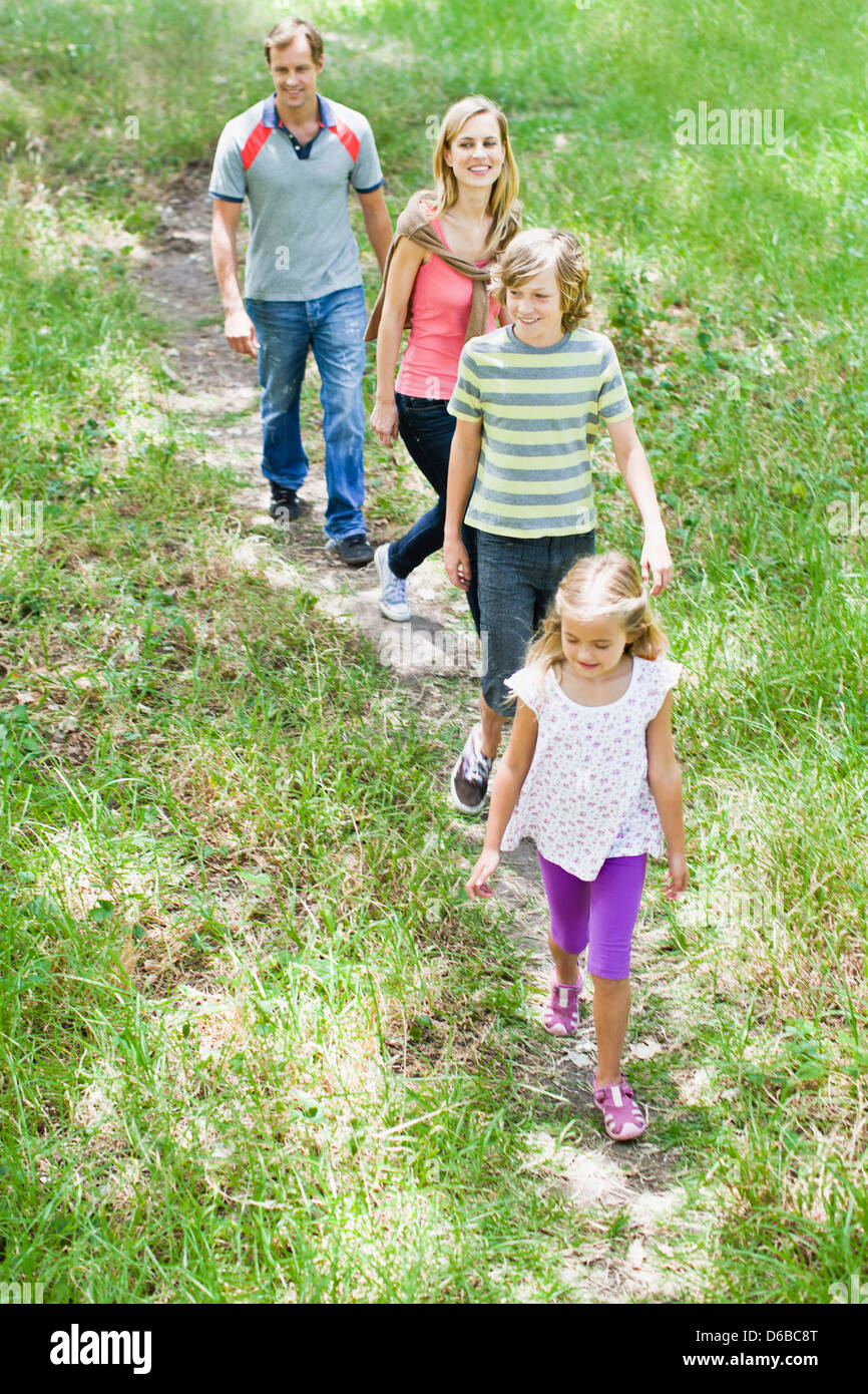 Family walking together in grass Stock Photo