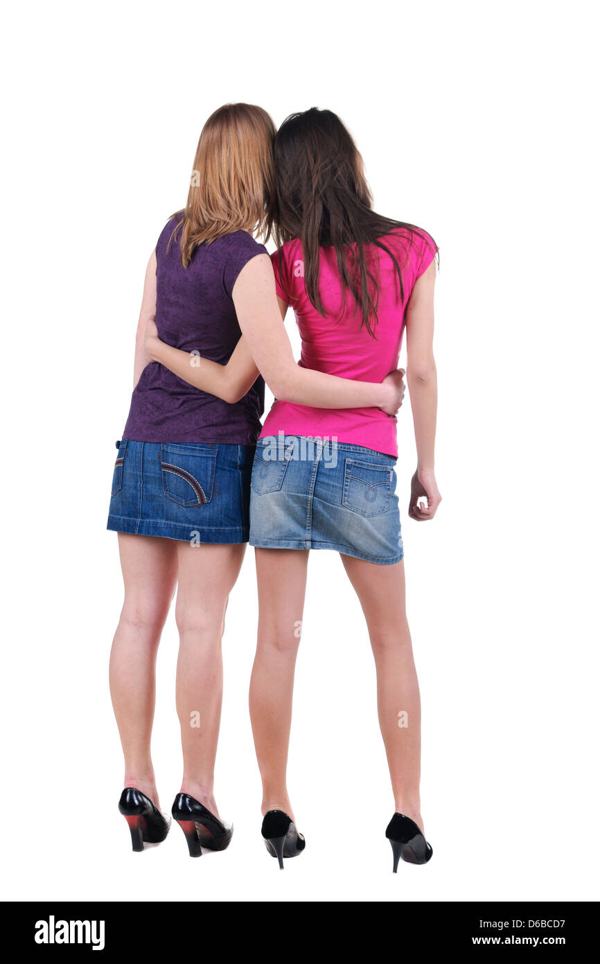 Two beautiful young woman. Rear view. Isolated over white Stock Photo ...