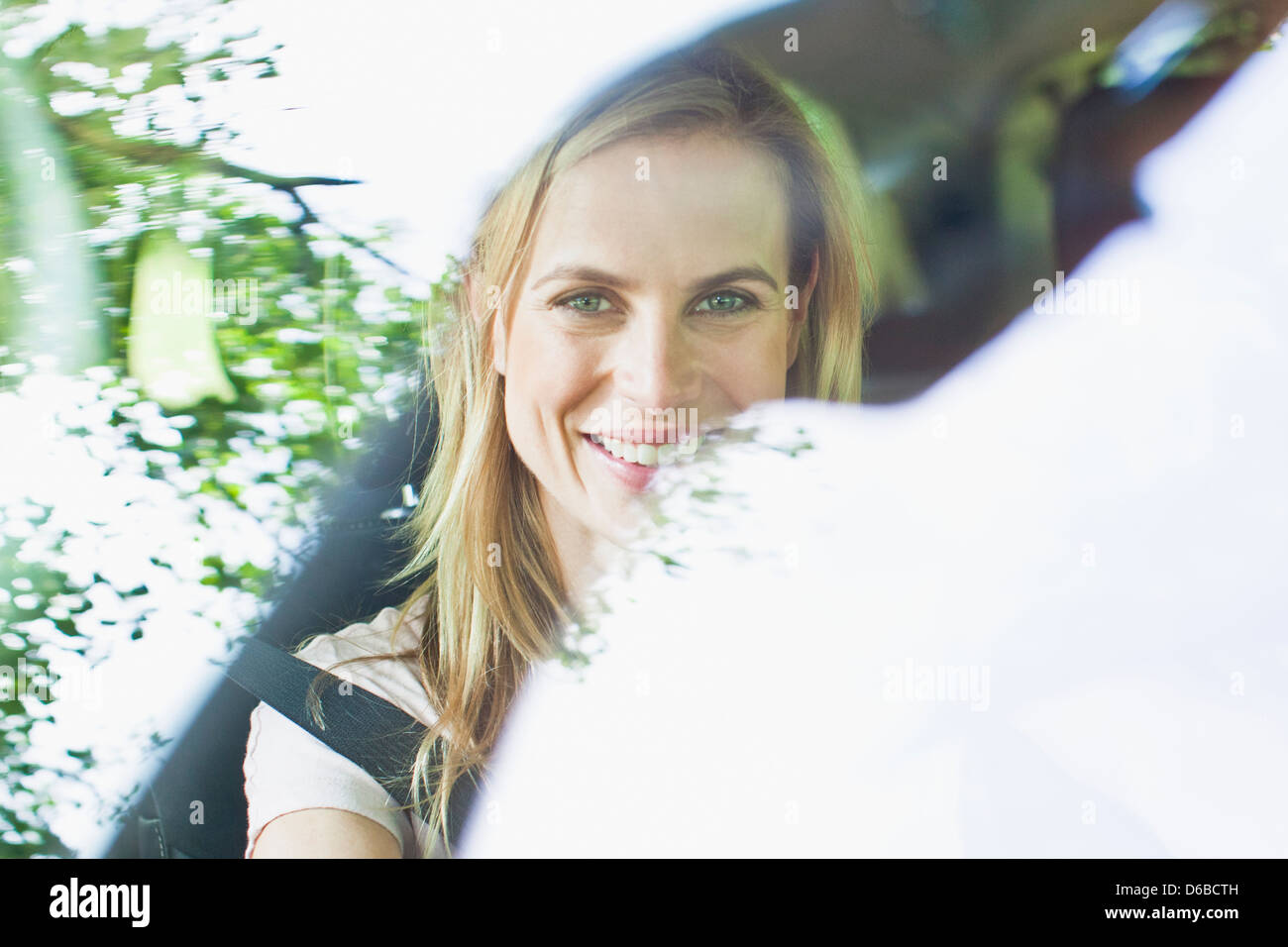 Smiling woman sitting in car Stock Photo