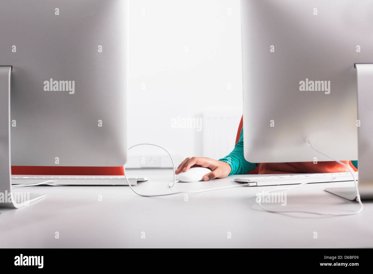 Girl using computer at desk Stock Photo