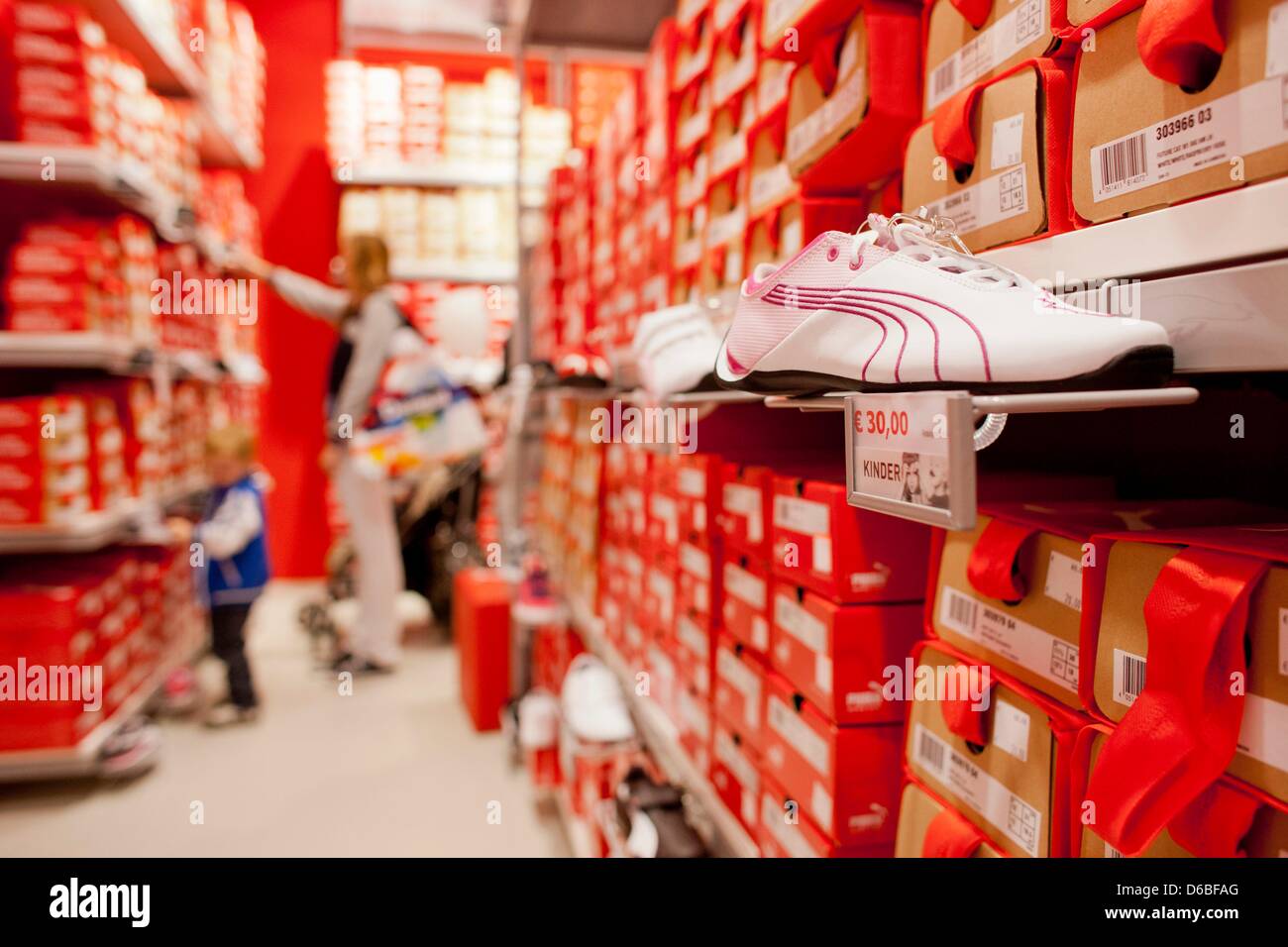 Shoppers look at clothes in the store of sportswear company Puma at the FOC  Ochtrup in Ochtrup, Germany, 30 August 2012. The only FActory-Outlet-Center  in Nort Rhine-Westphalia is now open for business.
