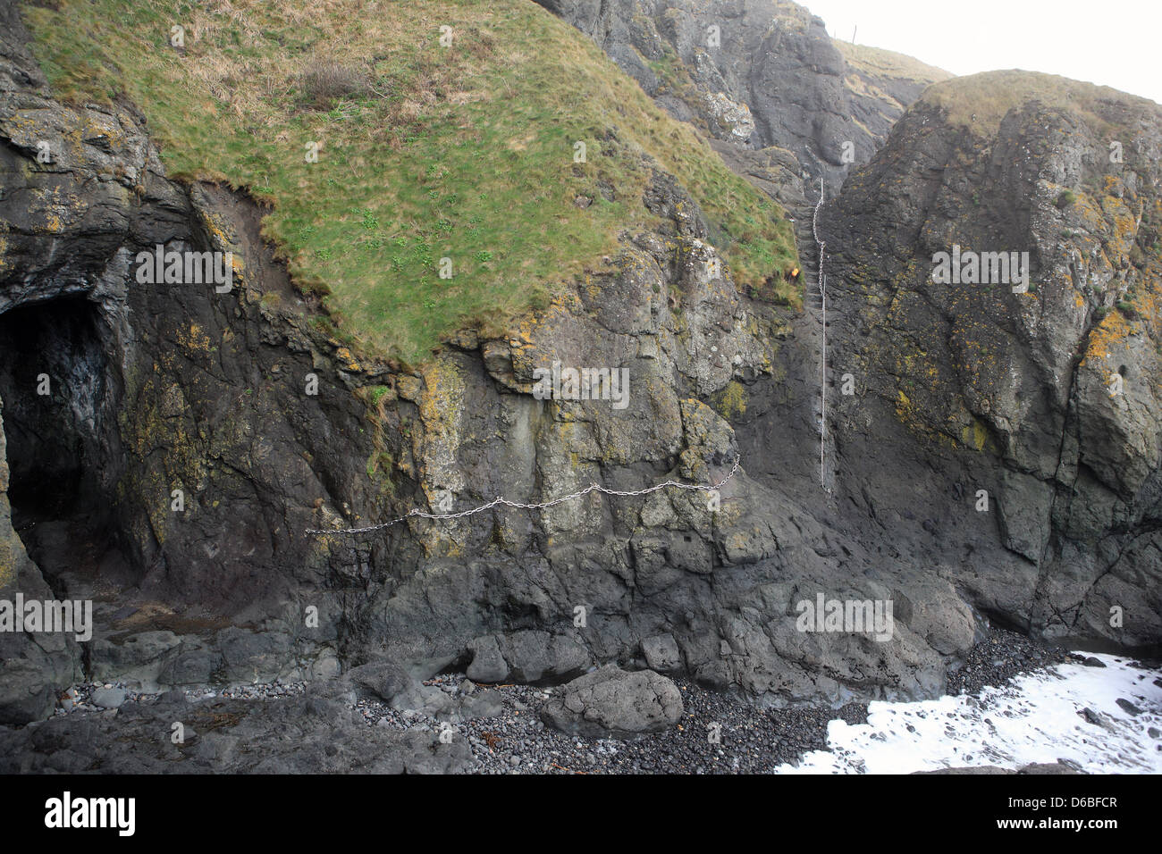 Chains on the cliff face to the west of Elie in Fife Scotland making this section of rock face accessible with care. Stock Photo