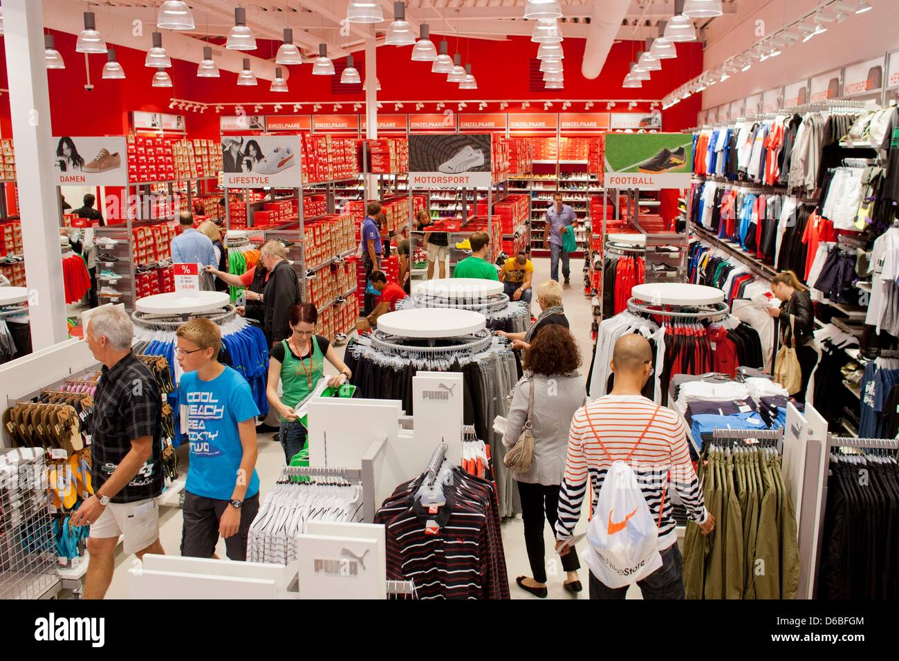 Shoppers look at clothes in the store of sportswear company Puma at the FOC  Ochtrup in Ochtrup, Germany, 30 August 2012. The only FActory-Outlet-Center  in Nort Rhine-Westphalia is now open for business.