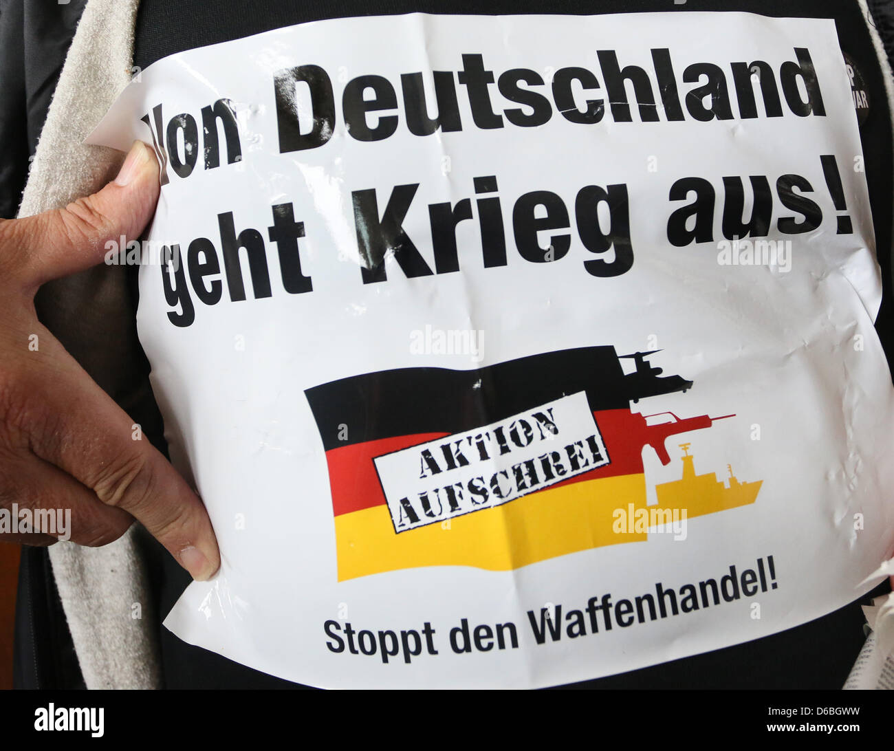 'War proceeds from Germany!' is written on a sign at the representative office of defence company Krauss-Maffei Wehrtechnik in Berlin, Germany, 31 August 2012. People demonstrated against Germany's international supply of tanks to conflicted areas under the motto 'Action Outcry - Stop Arms Trade'. Photo: Stephanie Pilick Stock Photo