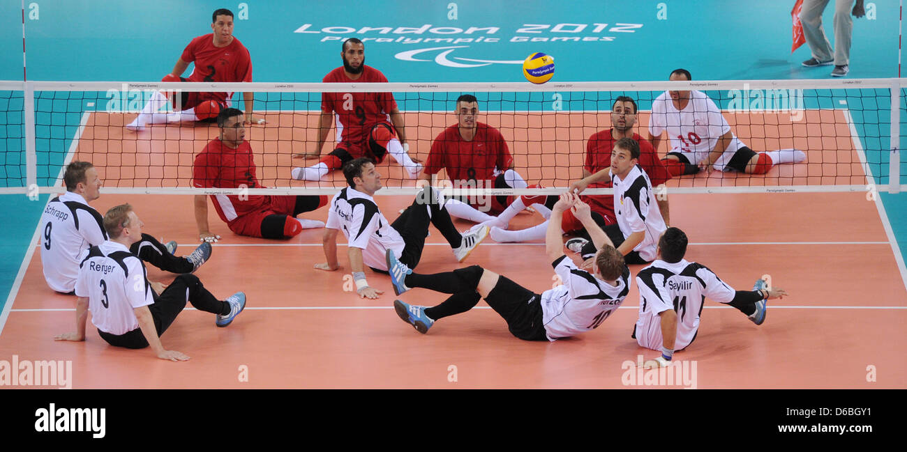 Christoph Herzog (front 3-R) of Germany hits the ball during the Preliminary Round Pool A match Germany vs Morocco of Men's Sitting Volleyball event in ExCel Centre during the London 2012 Paralympic Games, London, Great Britain, 31 August 2012. Photo: Julian Stratenschulte dpa  +++(c) dpa - Bildfunk+++ Stock Photo