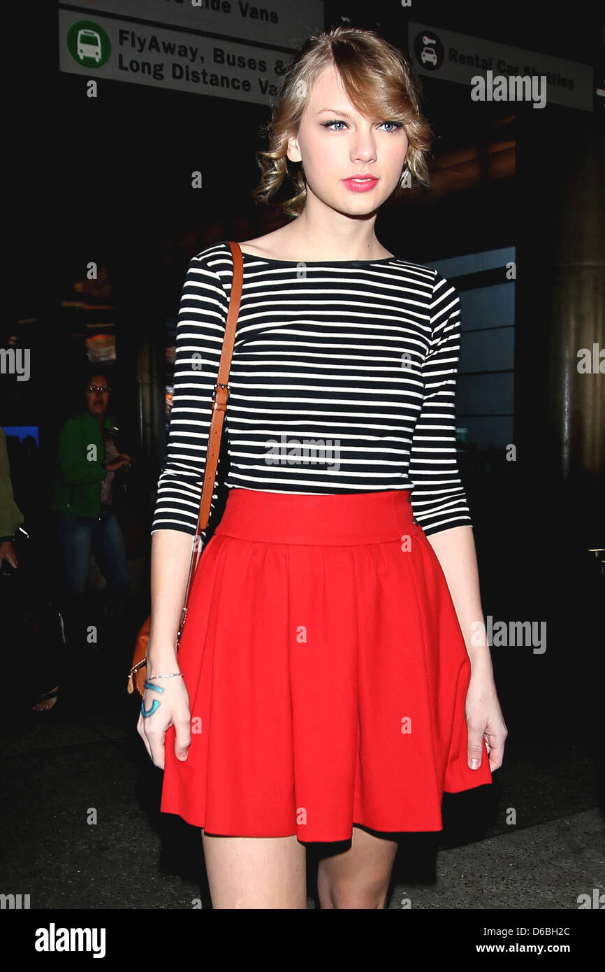 Taylor Swift wearing a striped shirt as ...