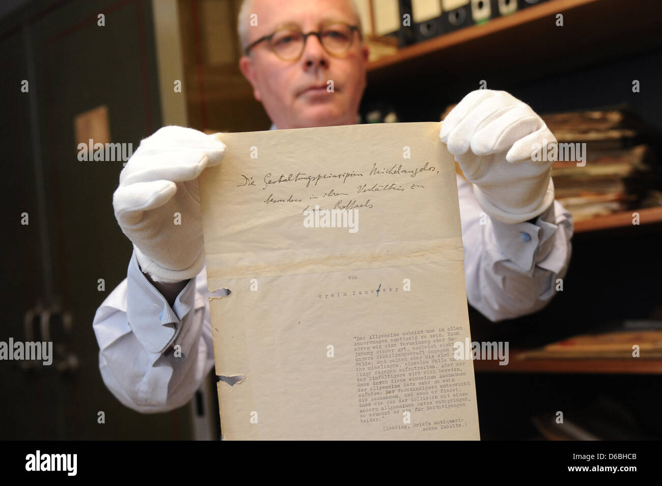 Art historian Stephan Klingen from the Central Institute of Art History holds the missing title page believed to be from the habilitation work on artist Michelangelo by famed art historian Erwin Panofsky (1892-1968) in Munich, Germany, 31 August 2012. Klingen found the page in an old NSDAP safe in the basement of the building. The institute is located in a former NSDAP administrati Stock Photo