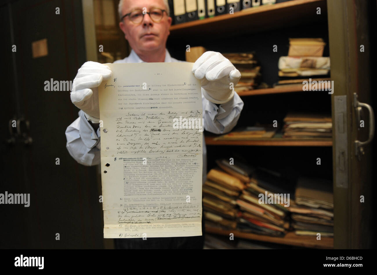 Art historian Stephan Klingen from the Central Institute of Art History holds a missing page believed to be from the habilitation work on artist Michelangelo by famed art historian Erwin Panofsky (1892-1968) in Munich, Germany, 31 August 2012. Klingen found the page in an old NSDAP safe in the basement of the building. The institute is located in a former NSDAP administration build Stock Photo