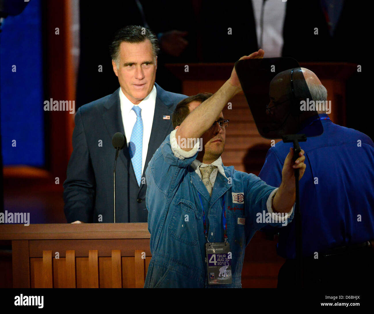 Mitt Romney, Republican Presidential Candidate, looks on as a staffer adjusts the teleprompter as he participates in a microphone check prior to the start of the day's proceedings at the 2012 Republican National Convention in Tampa Bay, Florida on Thursday, August 30, 2012. Credit: Ron Sachs / CNP.(RESTRICTION: NO New York or New Jersey Newspapers or newspapers within a 75 mile rad Stock Photo