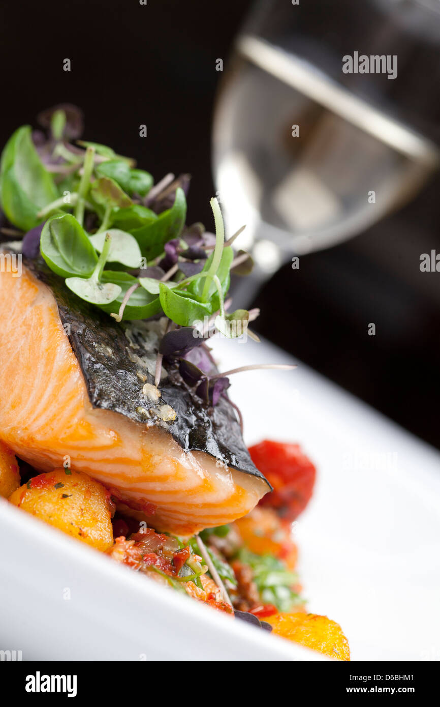 Salmon dish with a glass of white wine Stock Photo