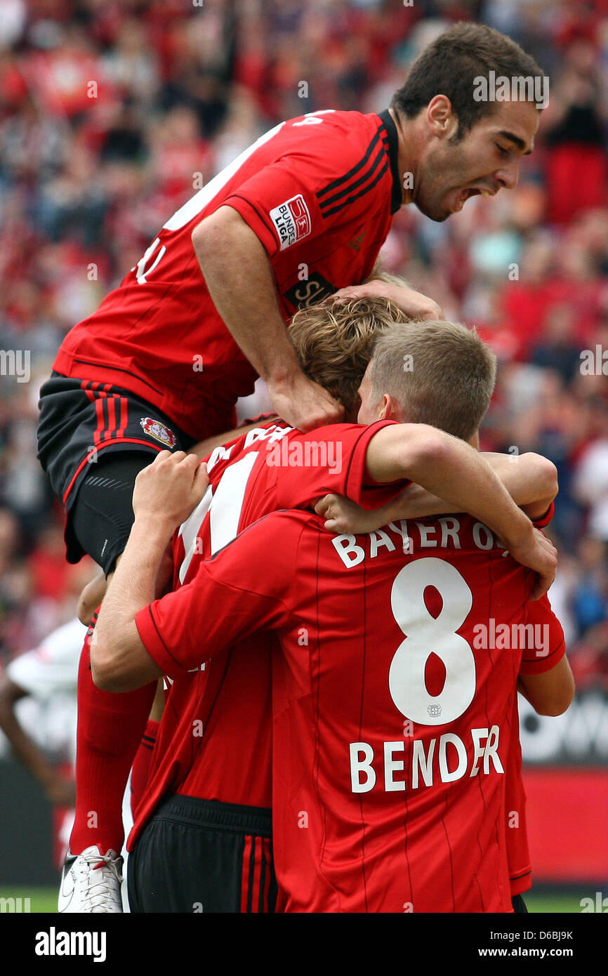 Leverkusen's Daniel Carvajal (above), Stefan Kiessling (C) and Lars Bender (R) celebrate the 1-0 goal of scorer Gonzalo Castro (covered) during the Bundesliga soccer match between Bayer 04 Leverkusen and SC Freiburg at BayArena in Leverkusen, Germany, 01 September 2012. Photo: KEVIN KUREK   (ATTENTION: EMBARGO CONDITIONS! The DFL permits the further utilisation of up to 15 pictures Stock Photo