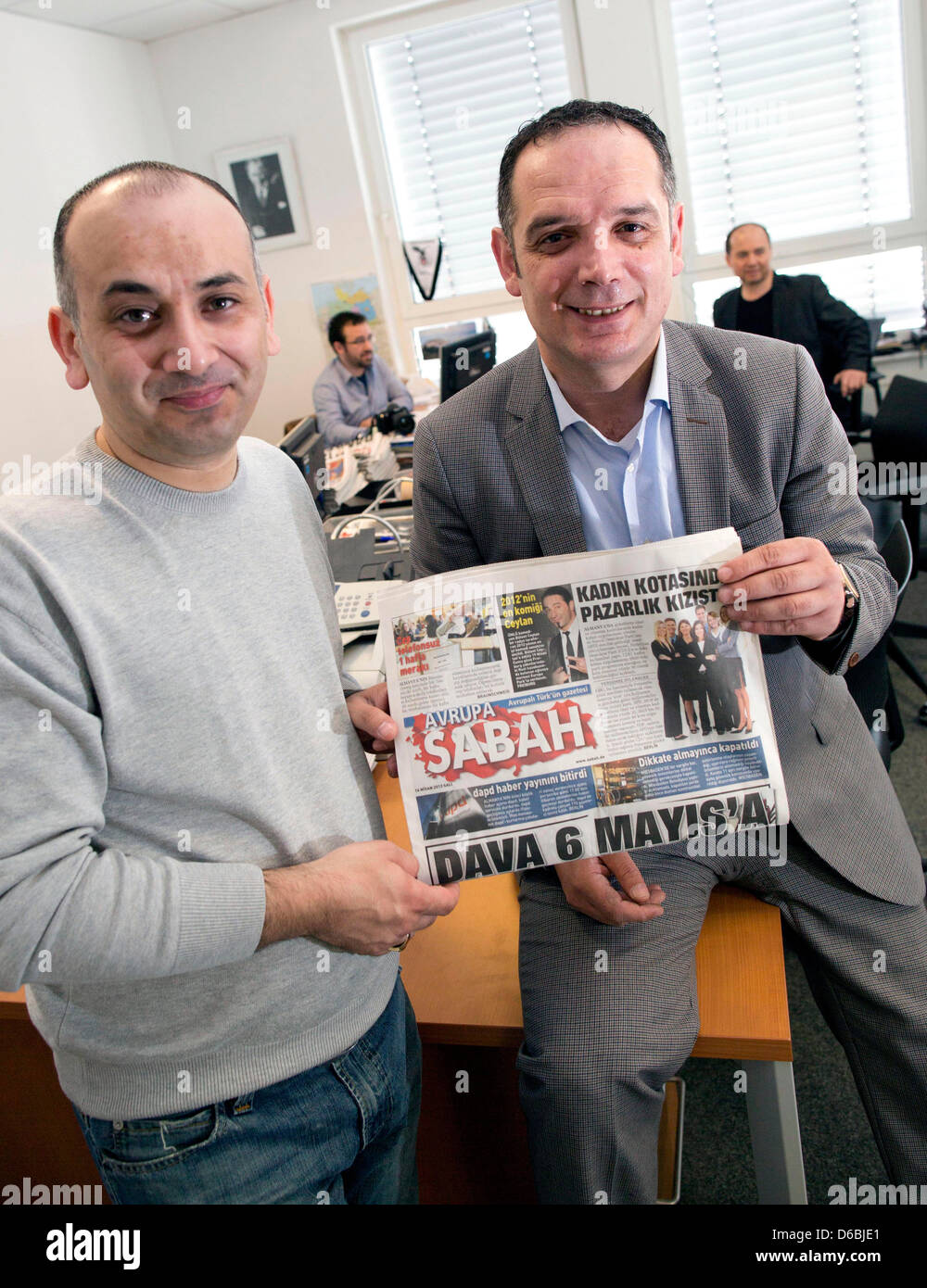 The vice chief editor Ismail Erel (L) and chief editor of Turkish newspaper 'Sabah' Mikdat Karaalioglu (R) sit in their office with this day's issure of their newspaper in Mörfelden-Walldorf, Germany, 16 April 2013. On the front page the postponing of the NSU trial to 6 May 2013 is covered. 'Sabah' had laid a constitutional complaint against distribution of the journalist's spots. Photo: FRANK RUMPENHORST Stock Photo