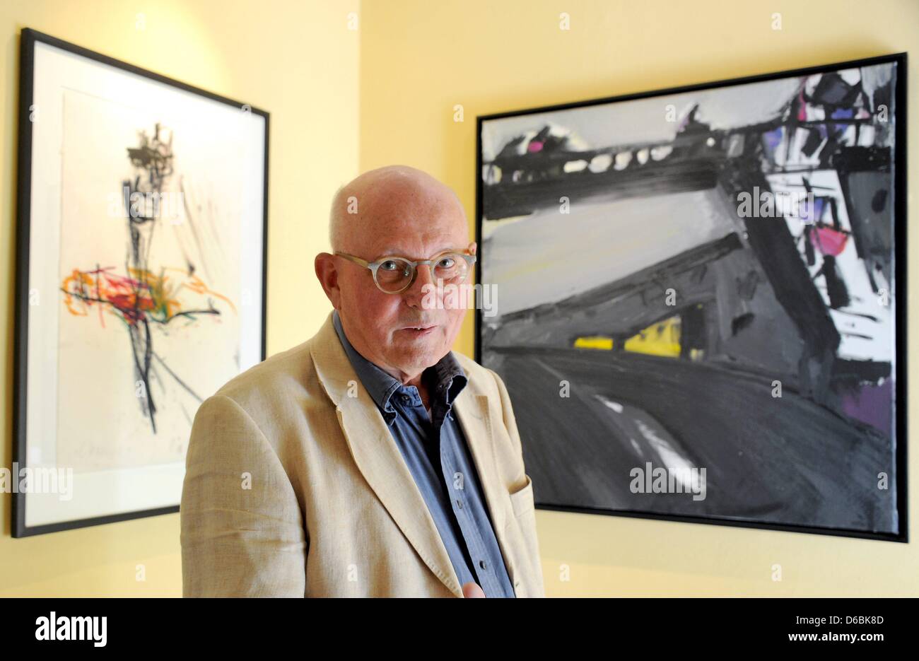 Physics professor Klaus Eberhard stands front of the paintings 'Orpheus I' (1996) by Hartwig Ebersbach and 'Fussgaengerbruecke verregnet' ('Rainy Pedestrian Bridge') (1992)  in his 'Galerie Hotel Leipziger Hof' in Leipzig, Germany, 23 August 2012. The around 450 artworks belong to Klaus Eberhard from Munich, who has the largest private collection of paintings from the Leipzig Schoo Stock Photo