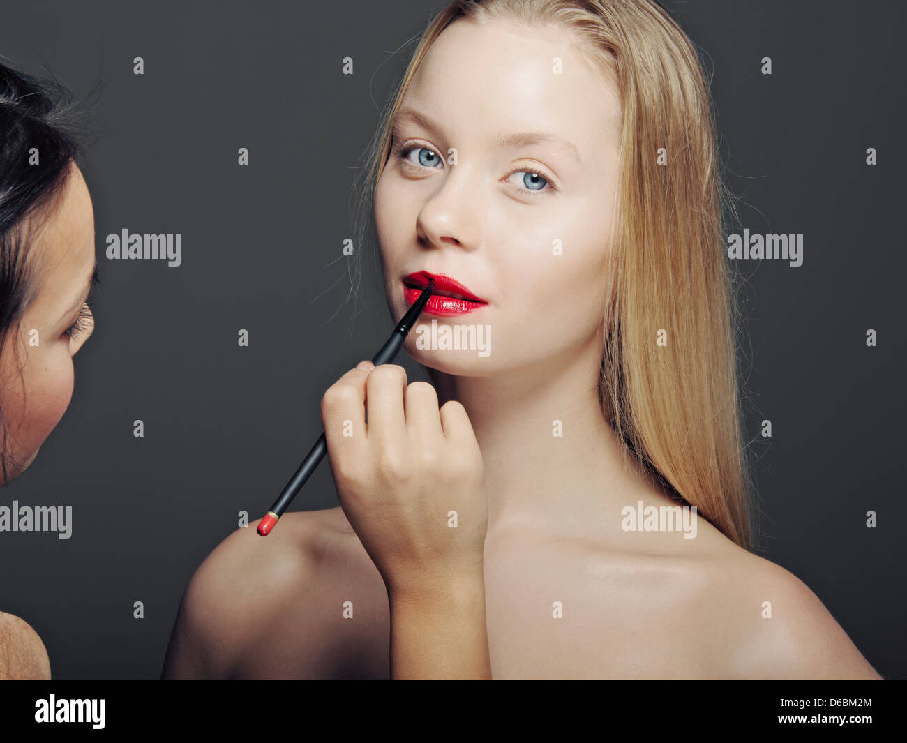 Woman having makeup applied Stock Photo