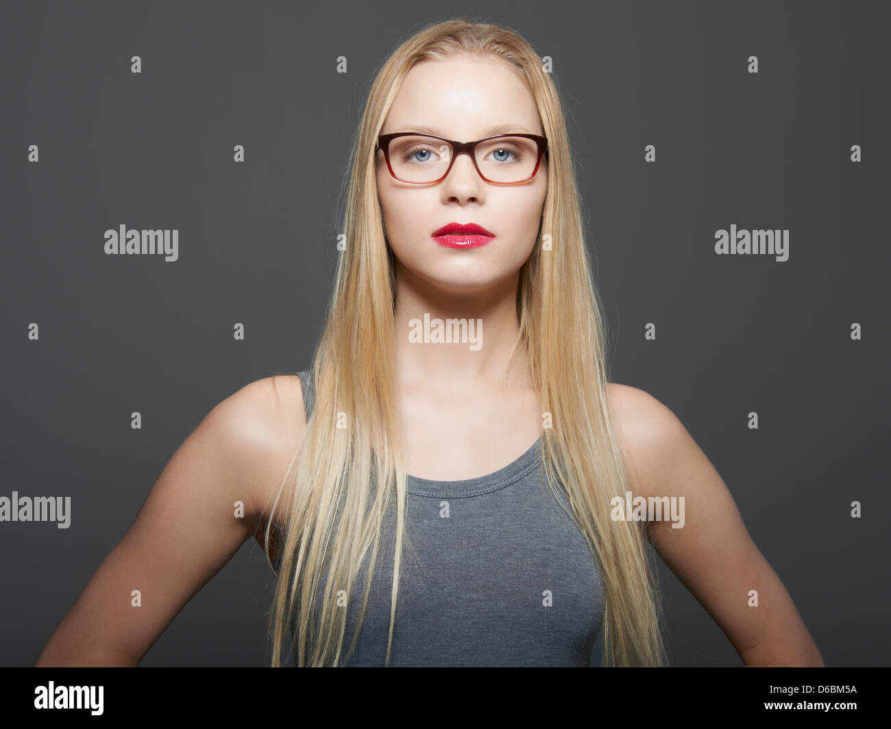 Woman in eyeglasses standing indoors Stock Photo