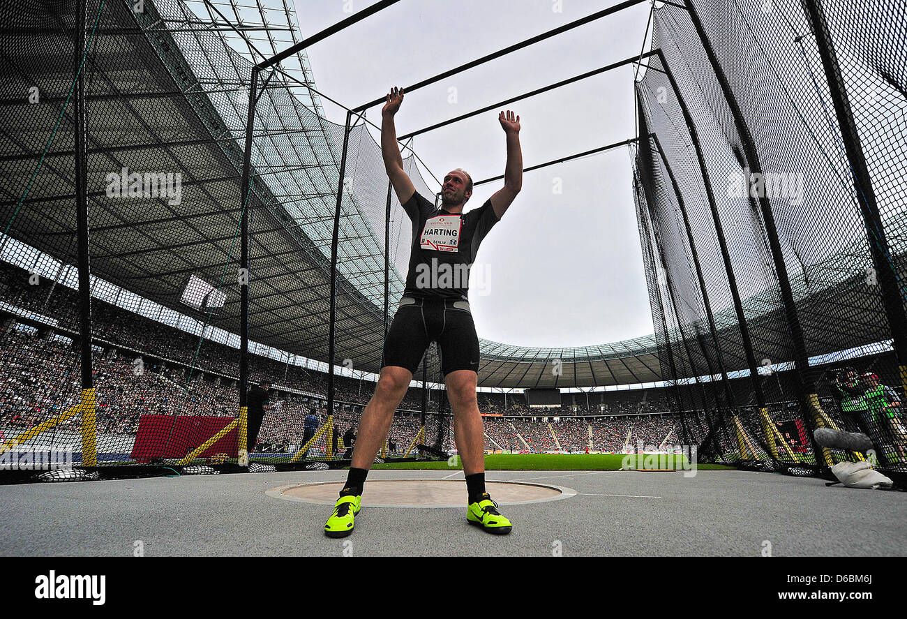 German discus thrower Robert Harting cheers after winning the discus