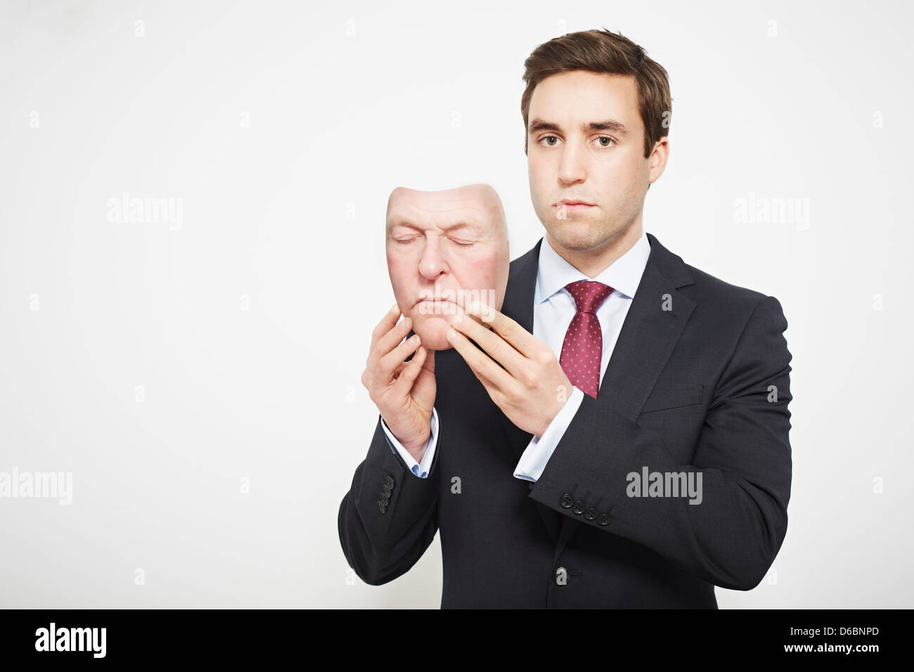 Businessman holding mask Stock Photo Alamy