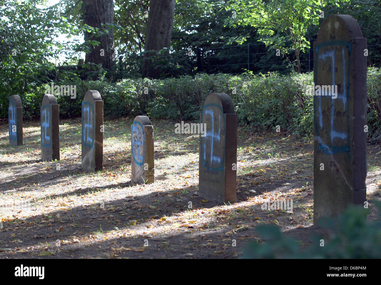 Neonazi graffitti desecrates tombstones at the Jewish cemetery in Kroepelin, Germany, 04 September 2012. The police are investigating. Photo: BERND WUESTNECK Stock Photo