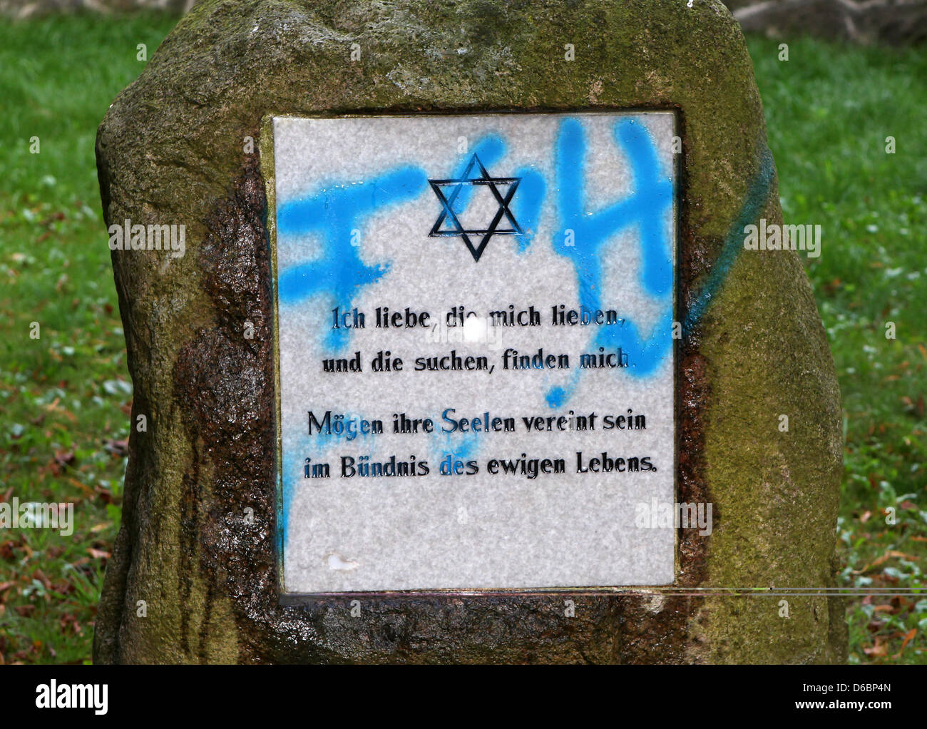 Neonazi graffitti desecrates tombstones at the Jewish cemetery in Kroepelin, Germany, 04 September 2012. The police are investigating. Photo: BERND WUESTNECK Stock Photo