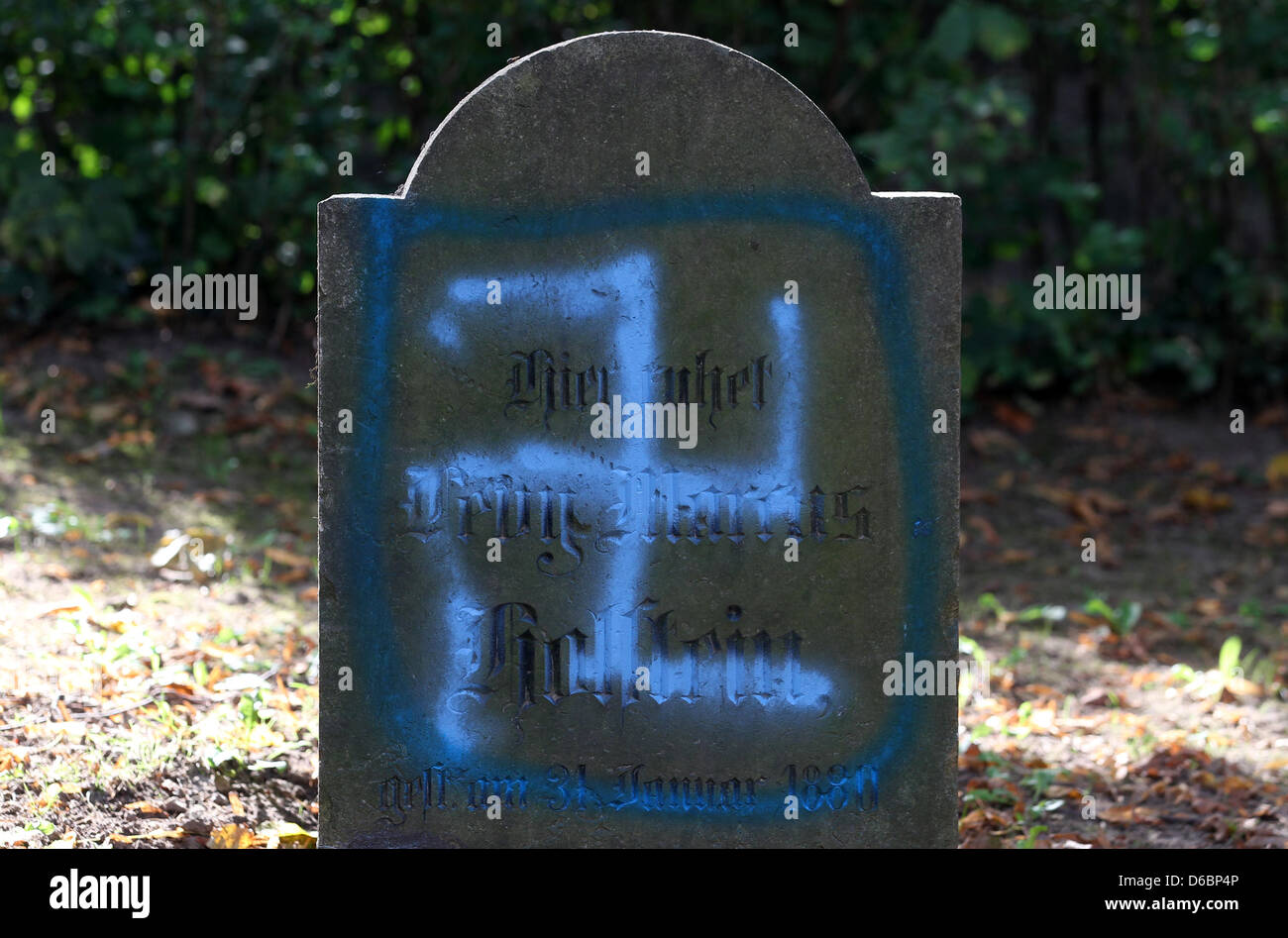 A neonazi graffitti desecrates a tombstone at the Jewish cemetery in Kroepelin, Germany, 04 September 2012. The police are investigating. Photo: BERND WUESTNECK Stock Photo