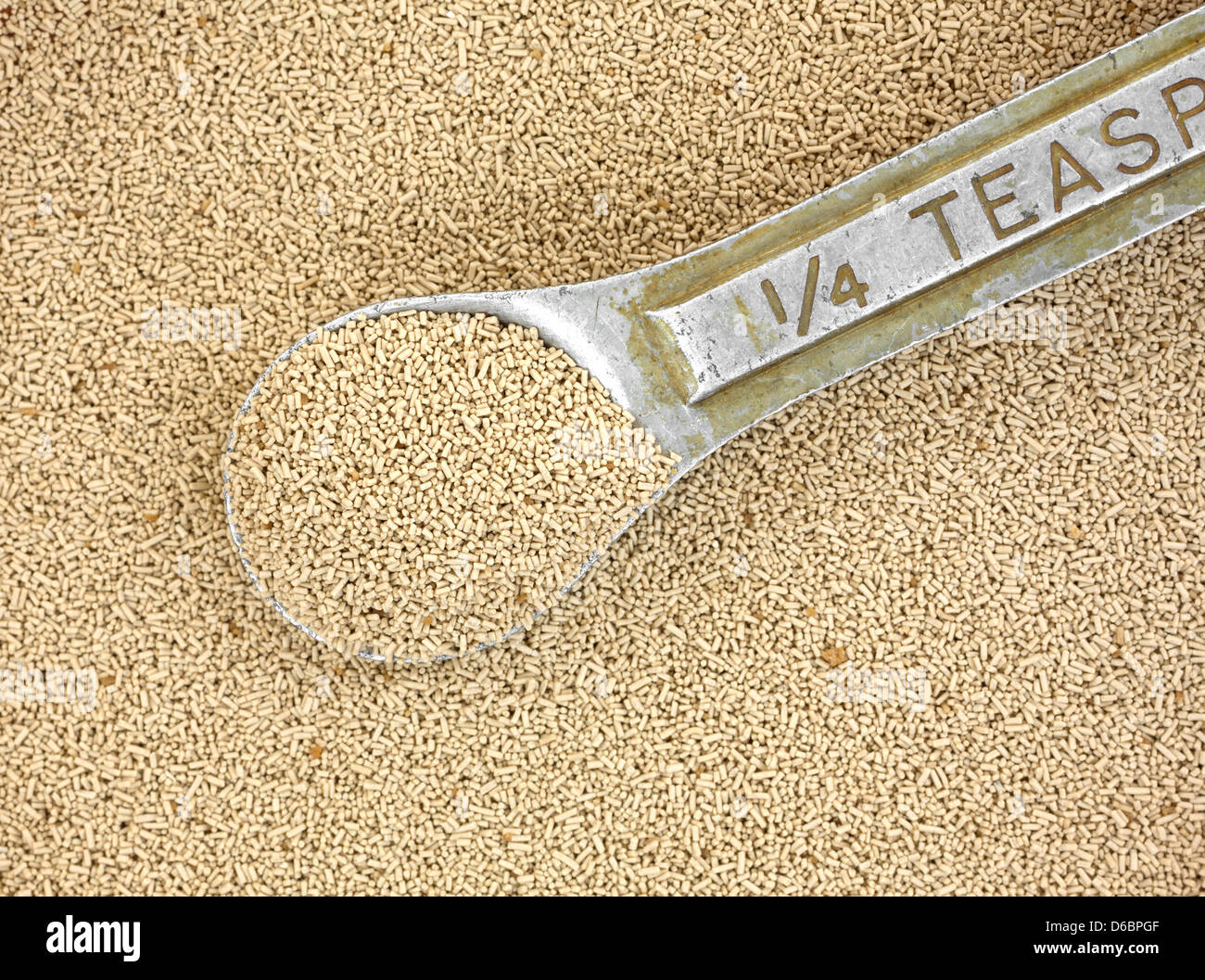 Close view of organic active dry yeast with a very old and worn measuring spoon Stock Photo Alamy