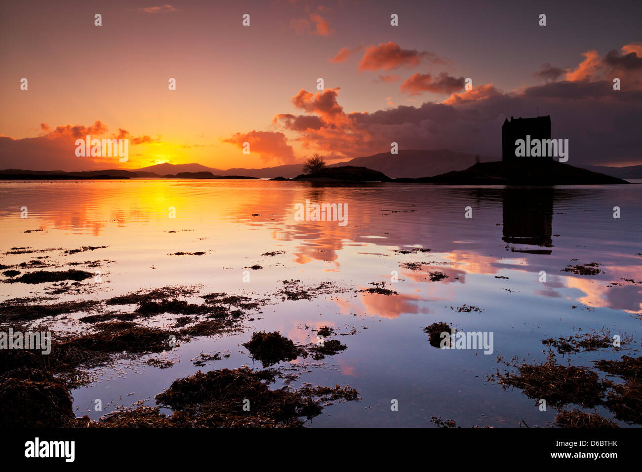 Silhouette sunset Castle Stalker Loch Laich Loch Linnhe Port Appin Keep Loch Laich inlet Loch Linnhe,Argyll and bute Scotland scottish highlands UK GB Stock Photo