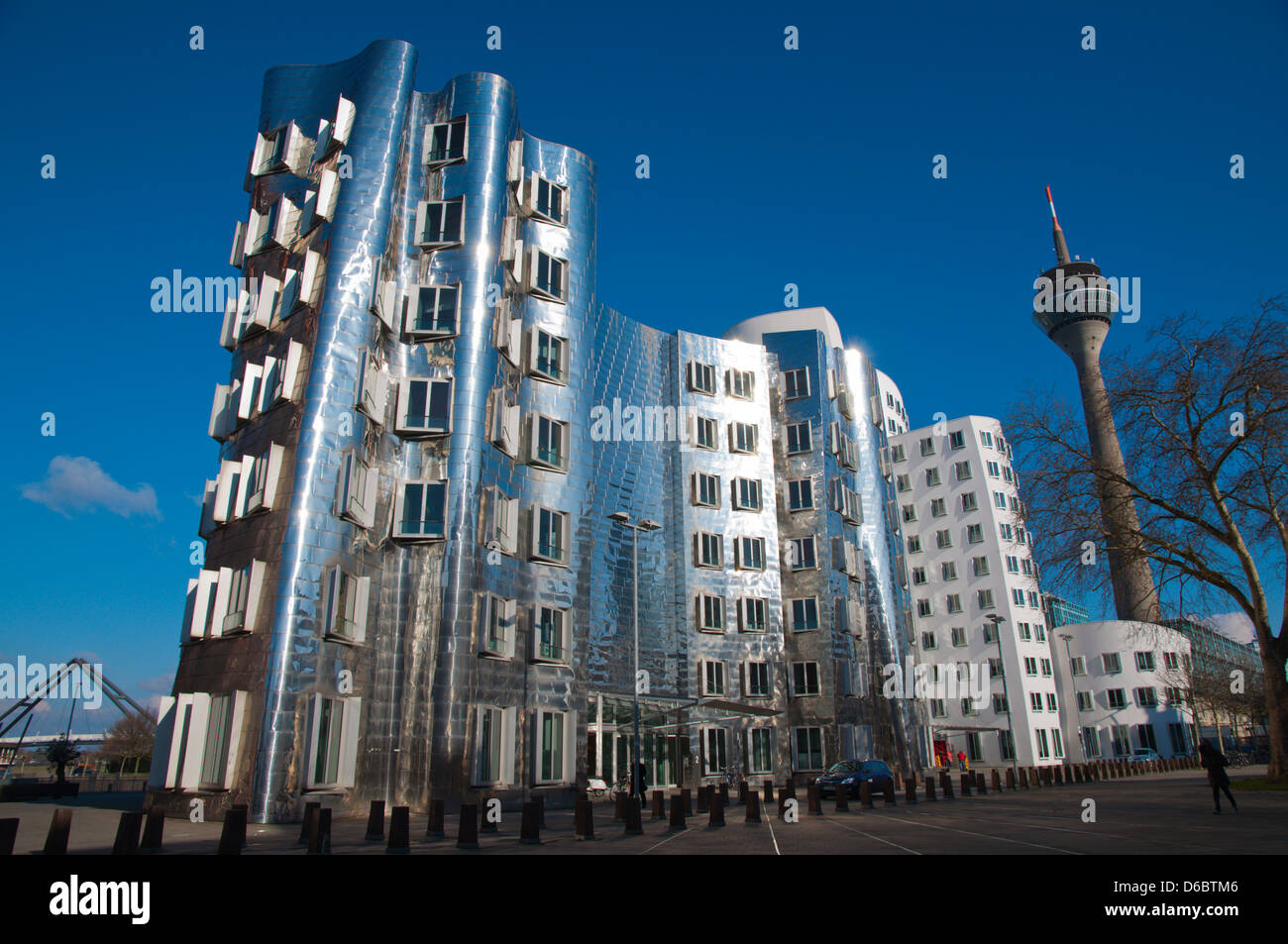 Neuer Zollhof buildings by F Gehry and Rheinturm tower Medienhafen the Media Harbour area Dusseldorf city Germany Europe Stock Photo