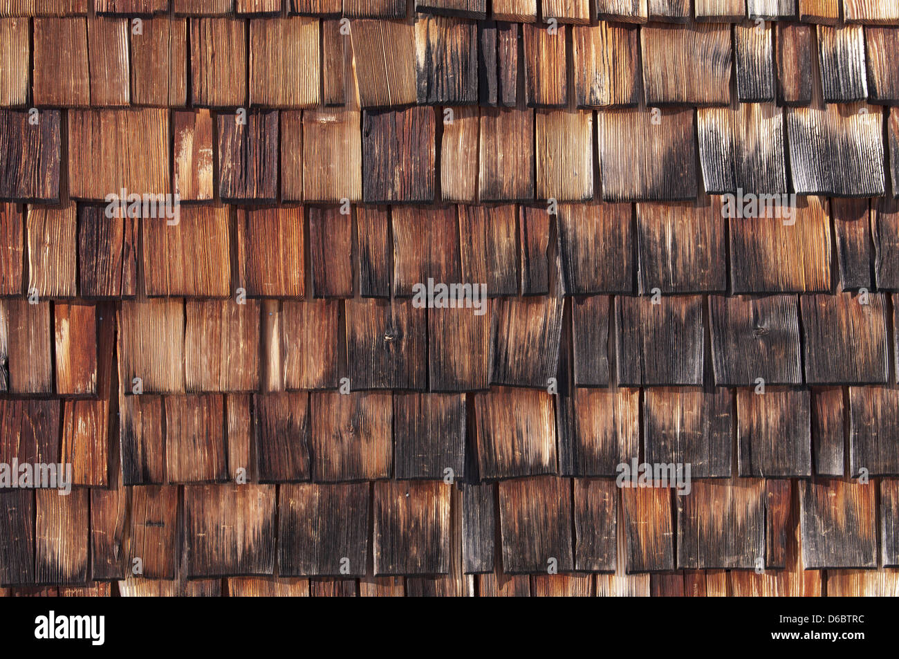 Texture - wooden shingles are tapered pieces of wood primarily used to cover roofs and walls of buildings, Bavaria, Germany. Stock Photo