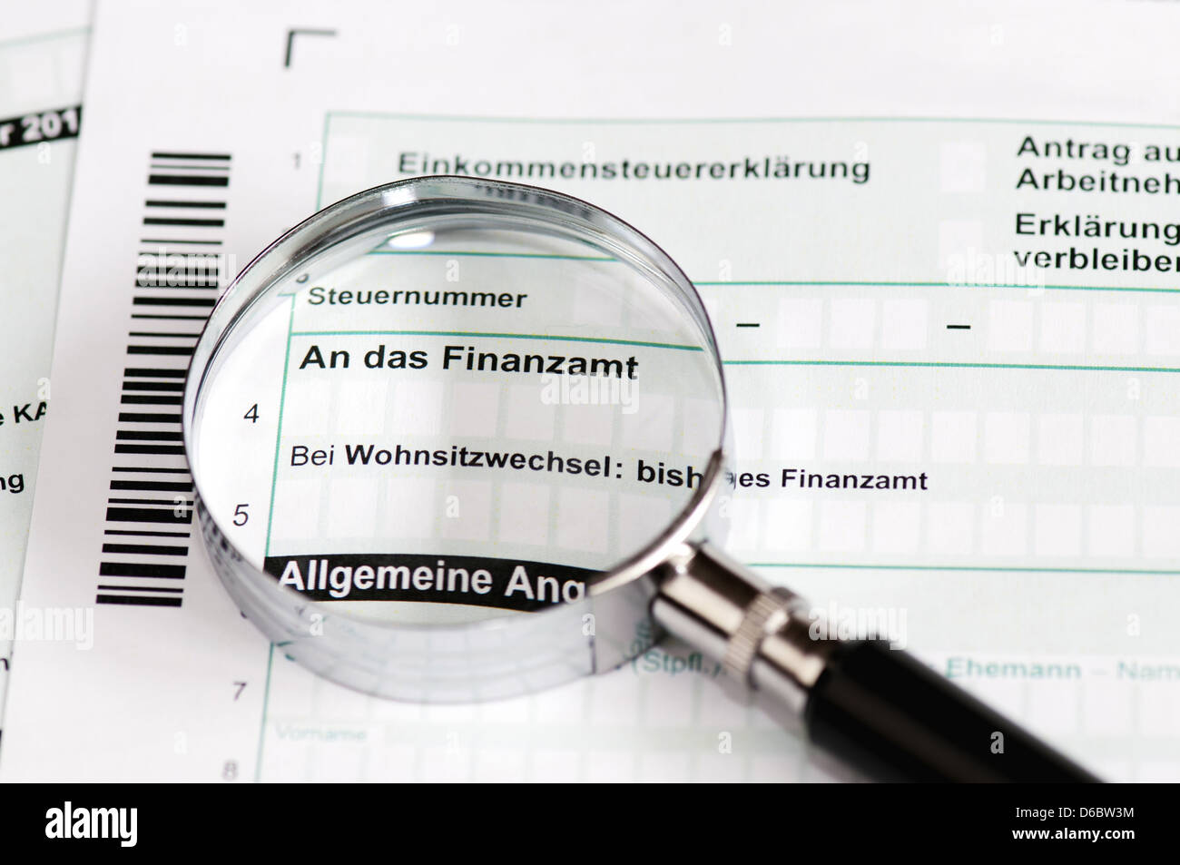 Close up of a german tax form with magnifier - Einkommenssteuererklaerung Stock Photo