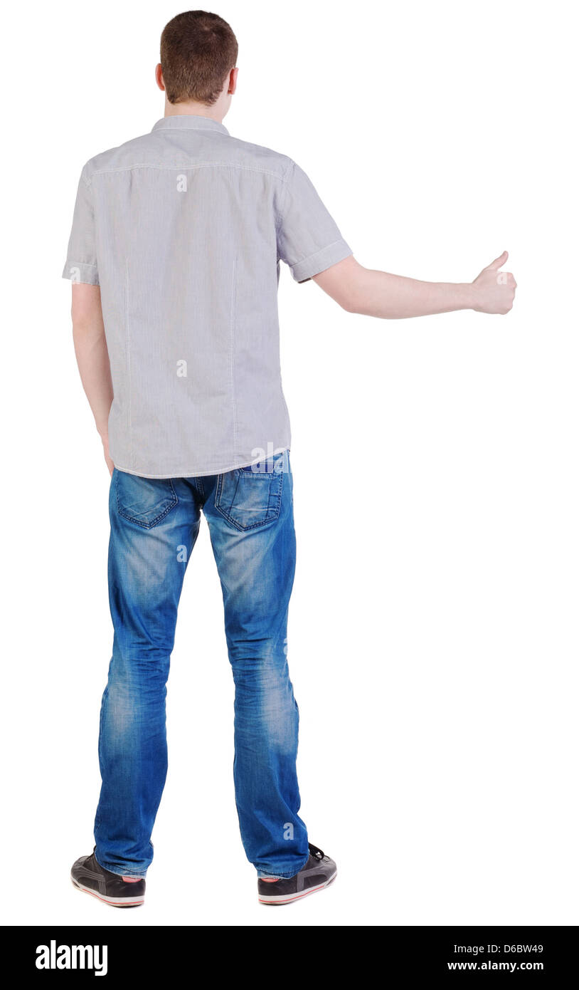 Back view of standing and showing thumb up young brunette man. Young ...