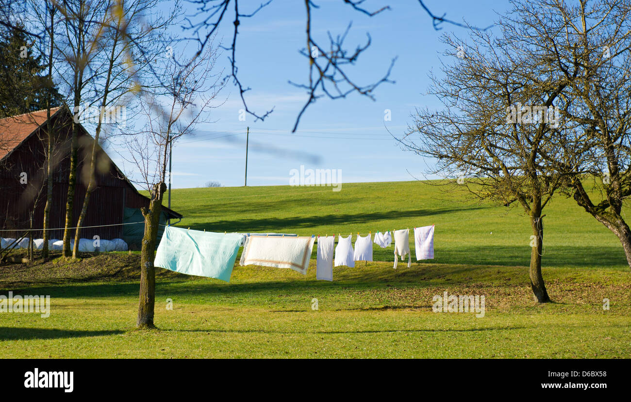 Laundry hangs to dry in the sun on a clothes line under a blue sky in Truilz, Germany, 03 January 2012. Photo: TOBIAS KLEINSCHMIDT Stock Photo