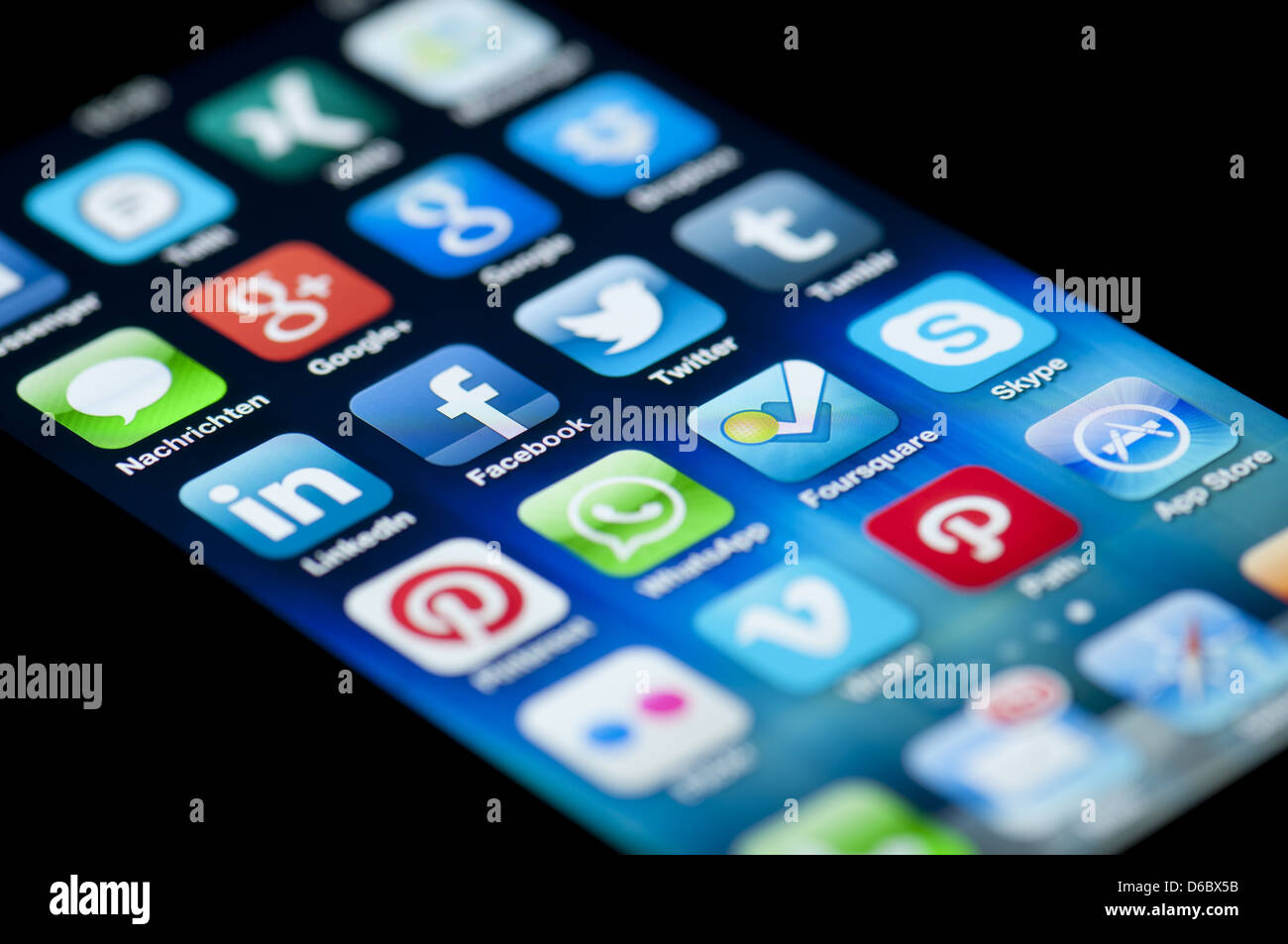 Close-up of an Apple iPhone 5 screen showing the App Store and  various social media apps. Stock Photo