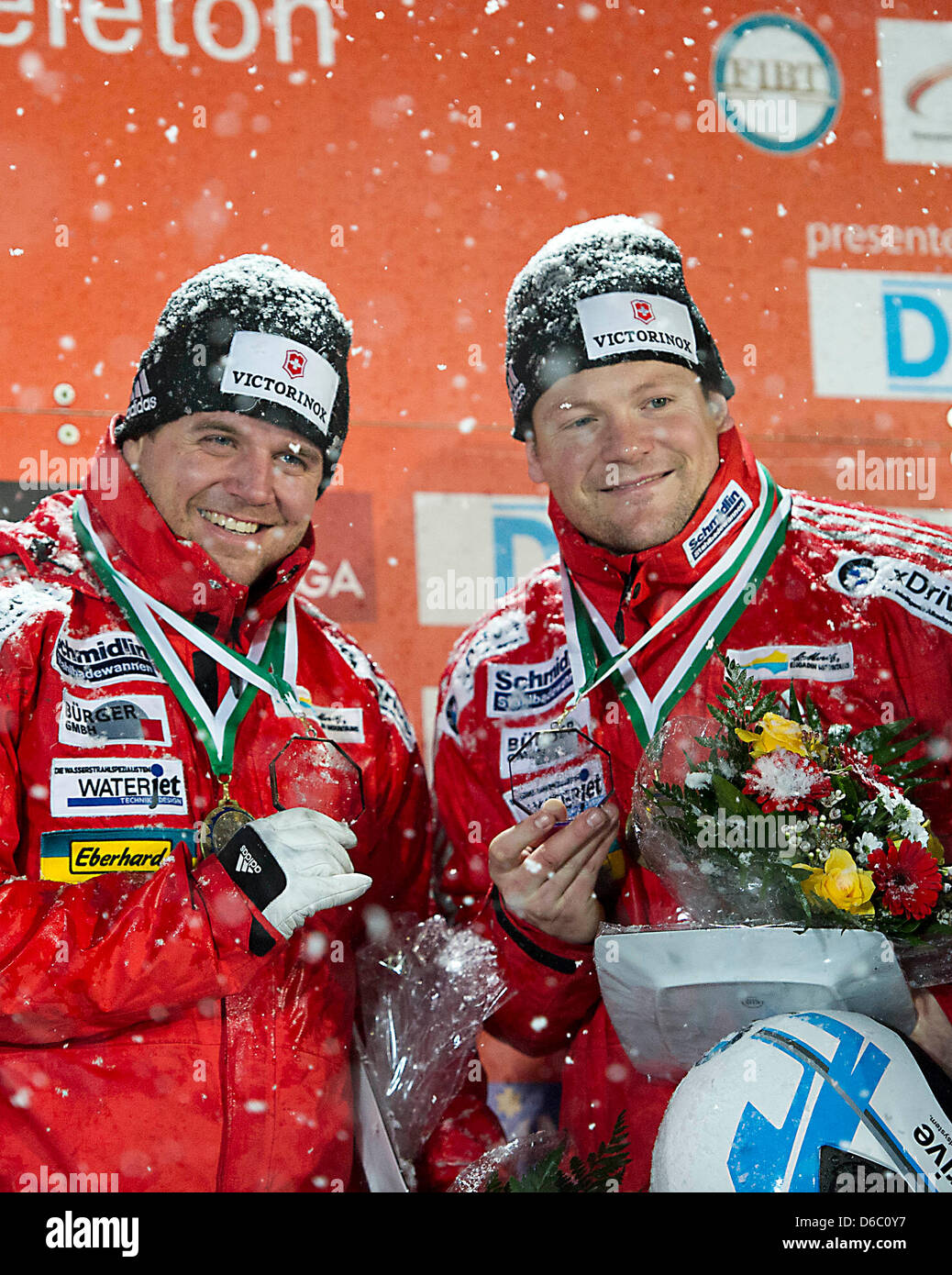 The Swiss bob pilot Beat Hefti (L) and his pusher Thomas Lampater celebrate their victory during the presentation ceremony at the Bobsled World Cup in Altenberg, Germany, 07 January 2012. Photo: Arno Burgi Stock Photo