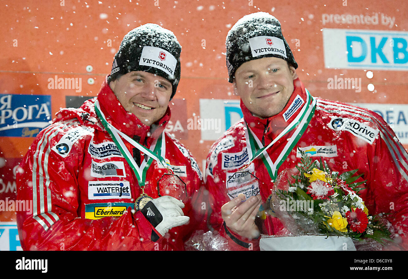 The Swiss bob pilot Beat Hefti (L) and his pusher Thomas Lampater celebrate their victory during the presentation ceremony at the Bobsled World Cup in Altenberg, Germany, 07 January 2012. Photo: Arno Burgi Stock Photo