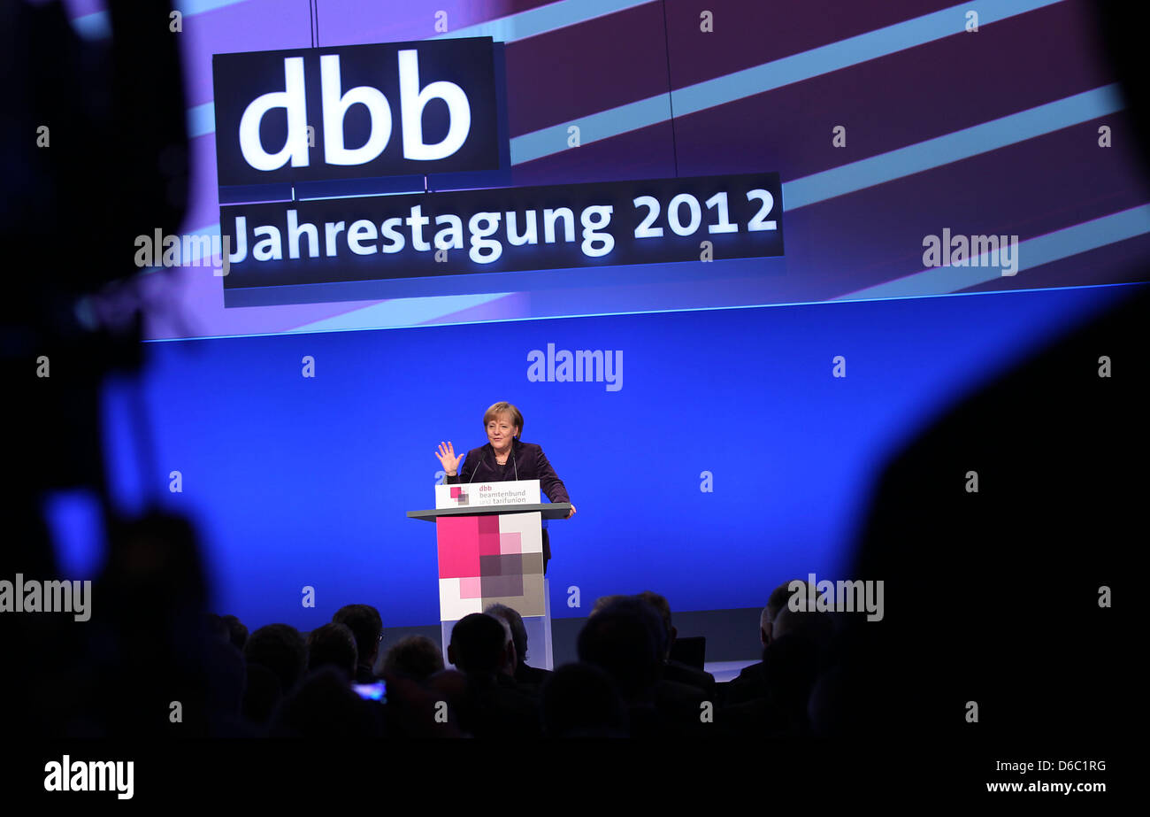 German Chancellor Angela Merkel speaks at the annual meeting of the German Civil Service Federation (DBB) in Cologne, Germany, 09 January 2012. The DBB chairman had recently demanded better pay and upward mobility for public service employees. Photo: OLIVER BERG Stock Photo