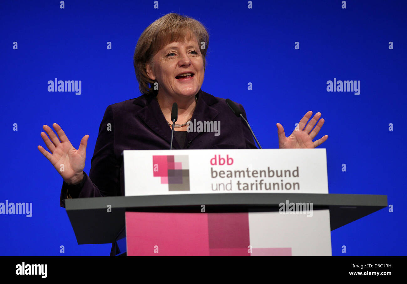 German Chancellor Angela Merkel speaks at the annual meeting of the German Civil Service Federation (DBB) in Cologne, Germany, 09 January 2012. The DBB chairman had recently demanded better pay and upward mobility for public service employees. Photo: OLIVER BERG Stock Photo