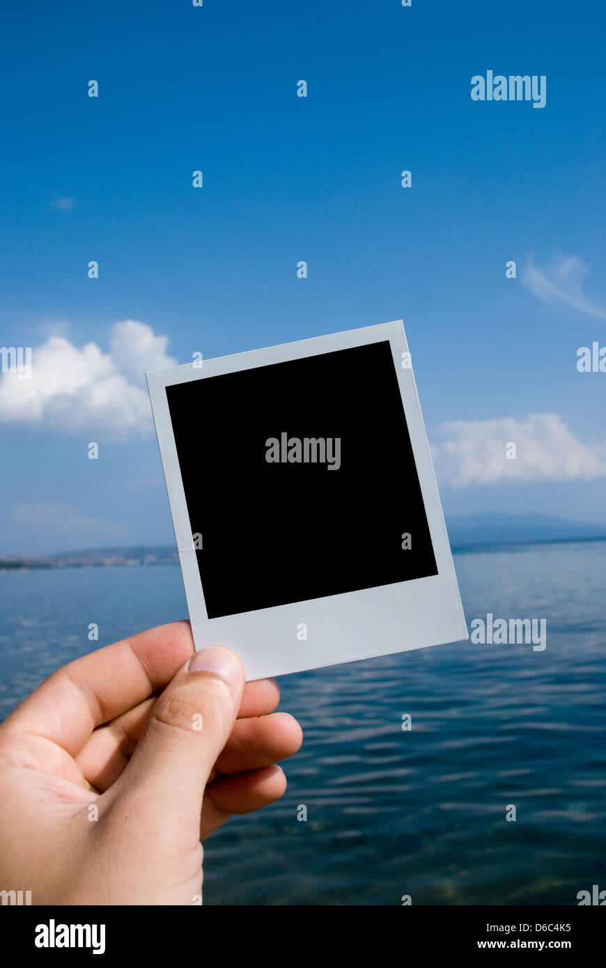Photo in a hand on nature sea background Stock Photo
